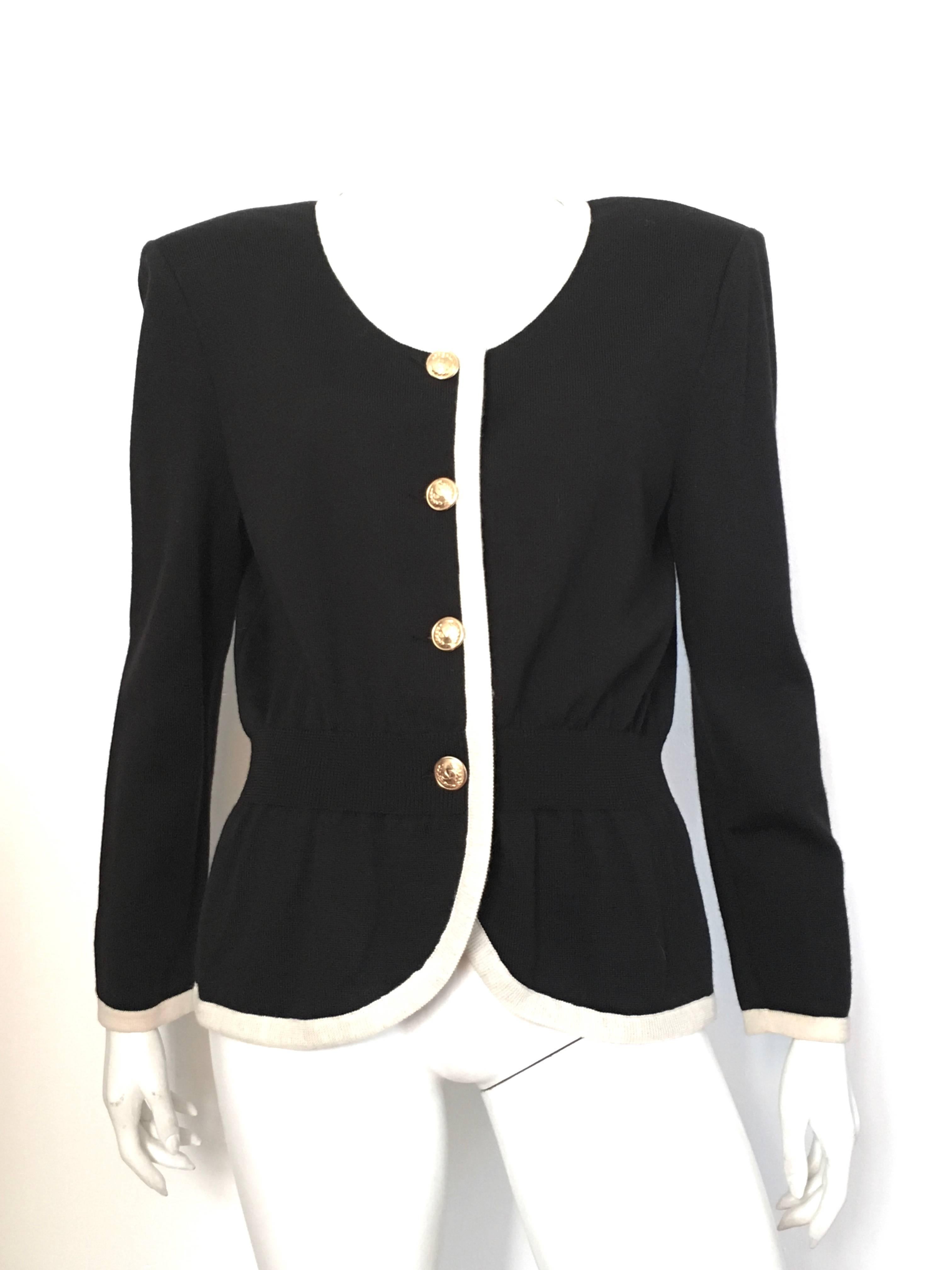 Valentino Miss V black wool knit cardigan with gold V buttons is labeled a size 14 / 48 but fits like an USA size 10/12. Ladies please grab your tape measure so you can properly measure your bust, waist & sleeves to make certain this item will