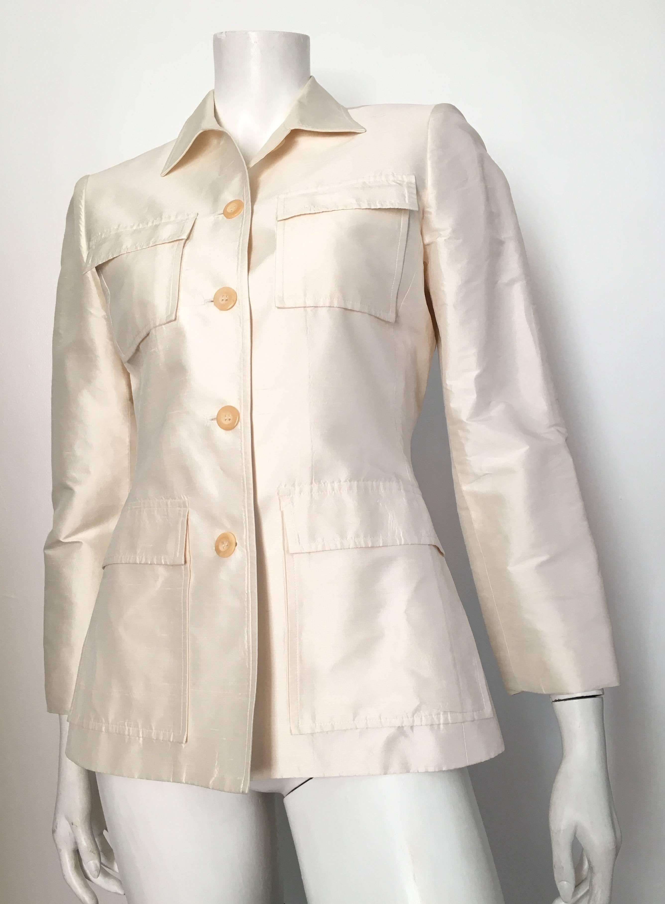 Oscar de la Renta white silk button up evening jacket is a size 6.  Ladies please grab your best friend, Mr. Tape Measure, so you can properly measure your bust, waistline & sleeves to make sure this lovely piece will fit your lovely body.  There