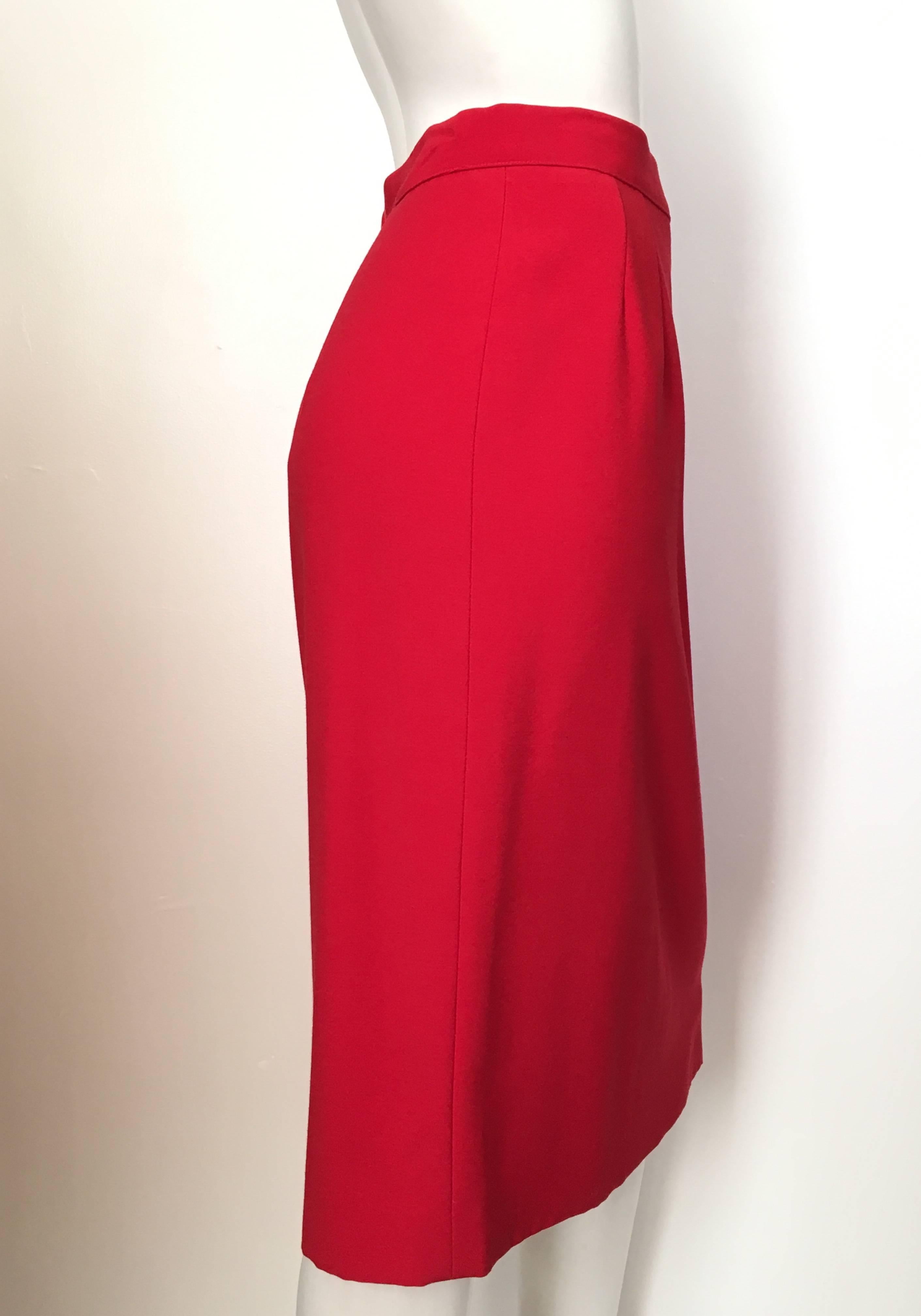 Valentino Miss V fire engine red wool skirt is an Italian size 48 and fits like an USA size 12. Ladies please grab your tape measure so you can properly measure your waist & hips to make certain this classic Valentino skirt will fit your lovely