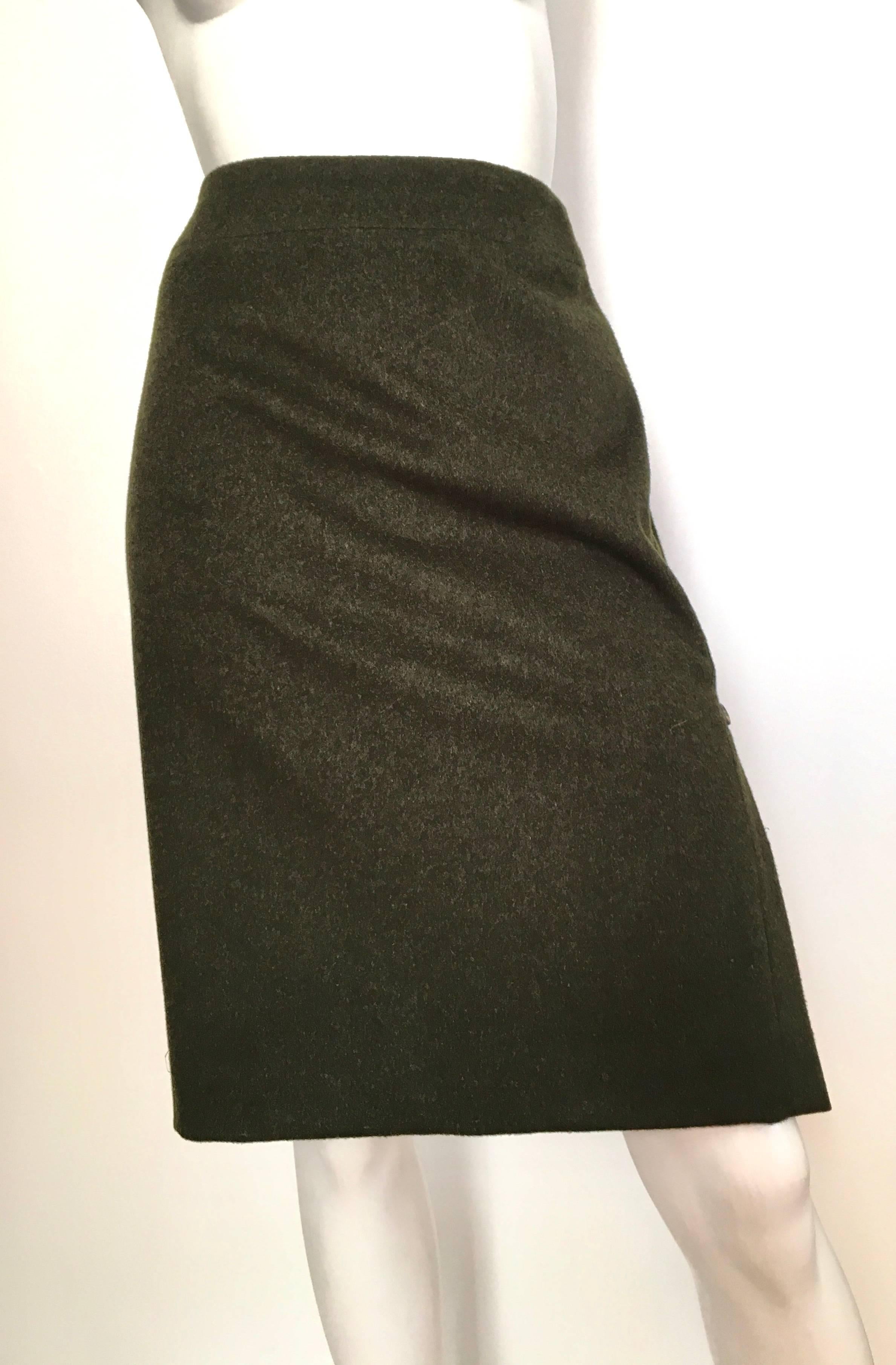 Carolina Herrera for Saks Fifth Avenue olive green wool & alpaca fabric skirt size 10. The last two button on the bottom are the only buttons that unbutton, the rest is pure decoration. Skirt is lined and made in Italy. Zipper on the back of