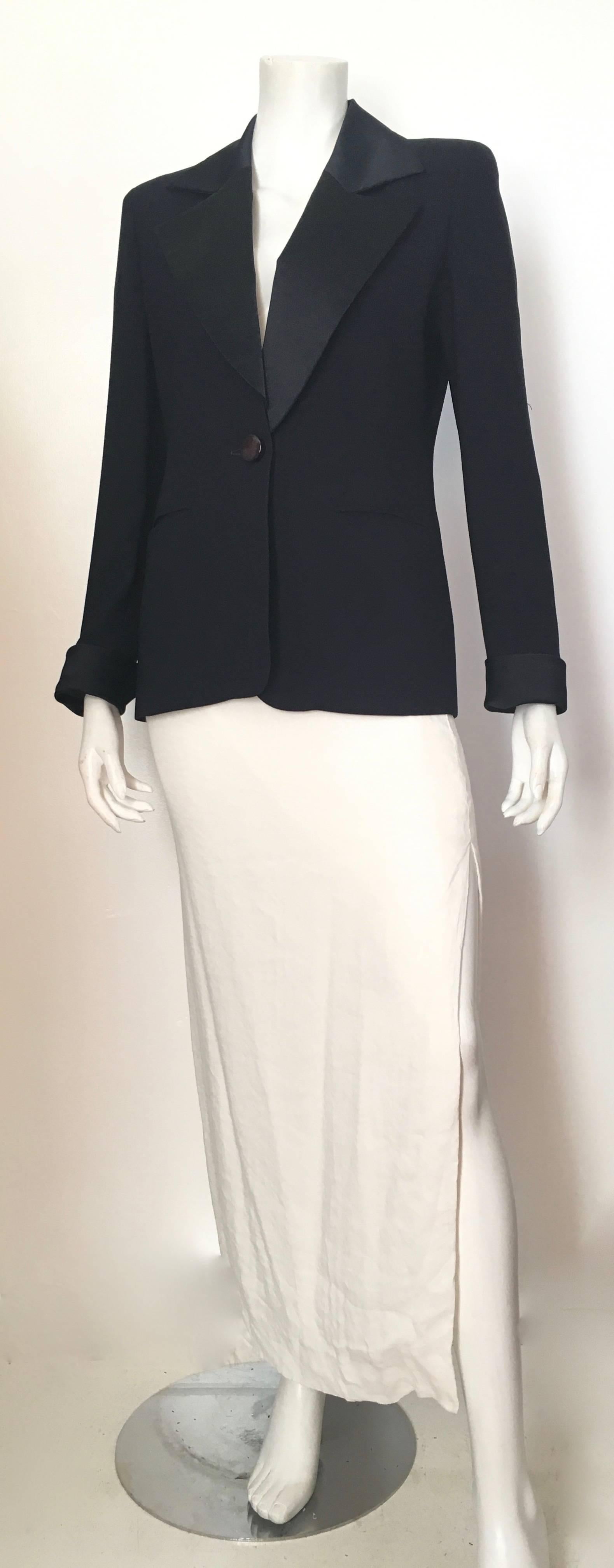 Christian Dior navy tuxedo jacket is a size 4. Match this jacket with your vintage 1980s Calvin Klein jeans and Tom Ford heels and go serve up some serious attitude.  Jacket is lined. 
Measurements are:
38" bust 96cm
35" waist
