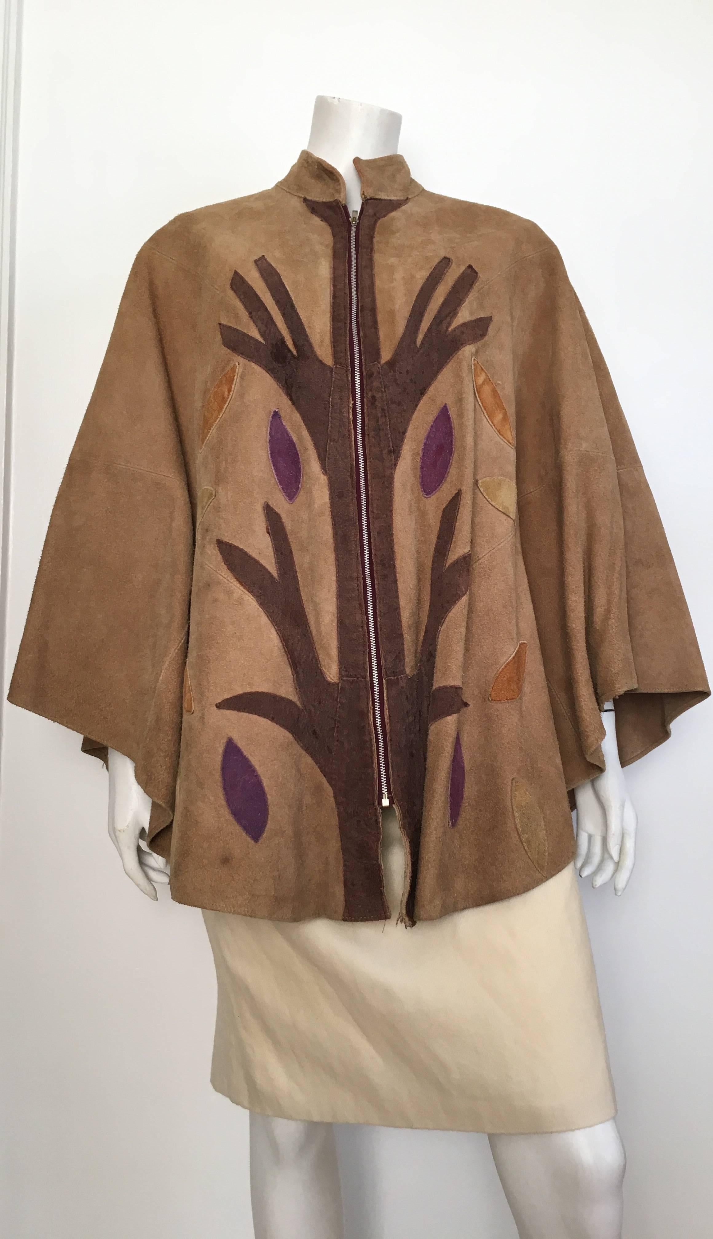 Queen of Capes 1980s tan suede zipper front with 'Tree of Life' pattern cape.  This gorgeous suede cape will fit size 2, 4, 6, 8 comfortably. This suede cape is over 30 years ago and still looks amazing today. Capes never go out of STYLE nor should