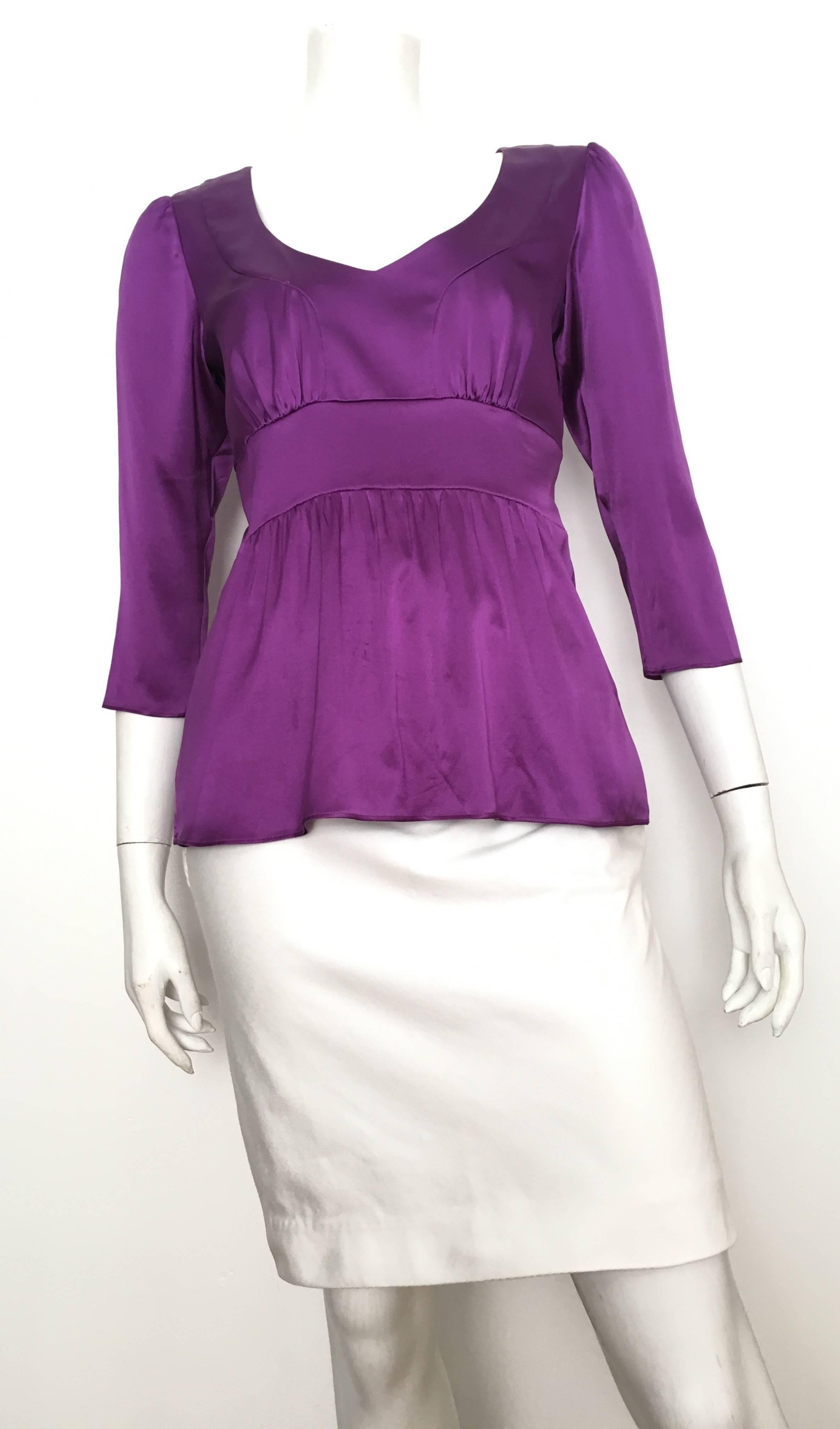 ETRO silk purple loose and flowing boho blouse is an Italian size 42 and fits like an USA size 6.
Low cut neckline and sleeves are 3/4 length.  This blouse does not have a zipper. 
Measurements are:
38" bust 97cm
29" in waist area