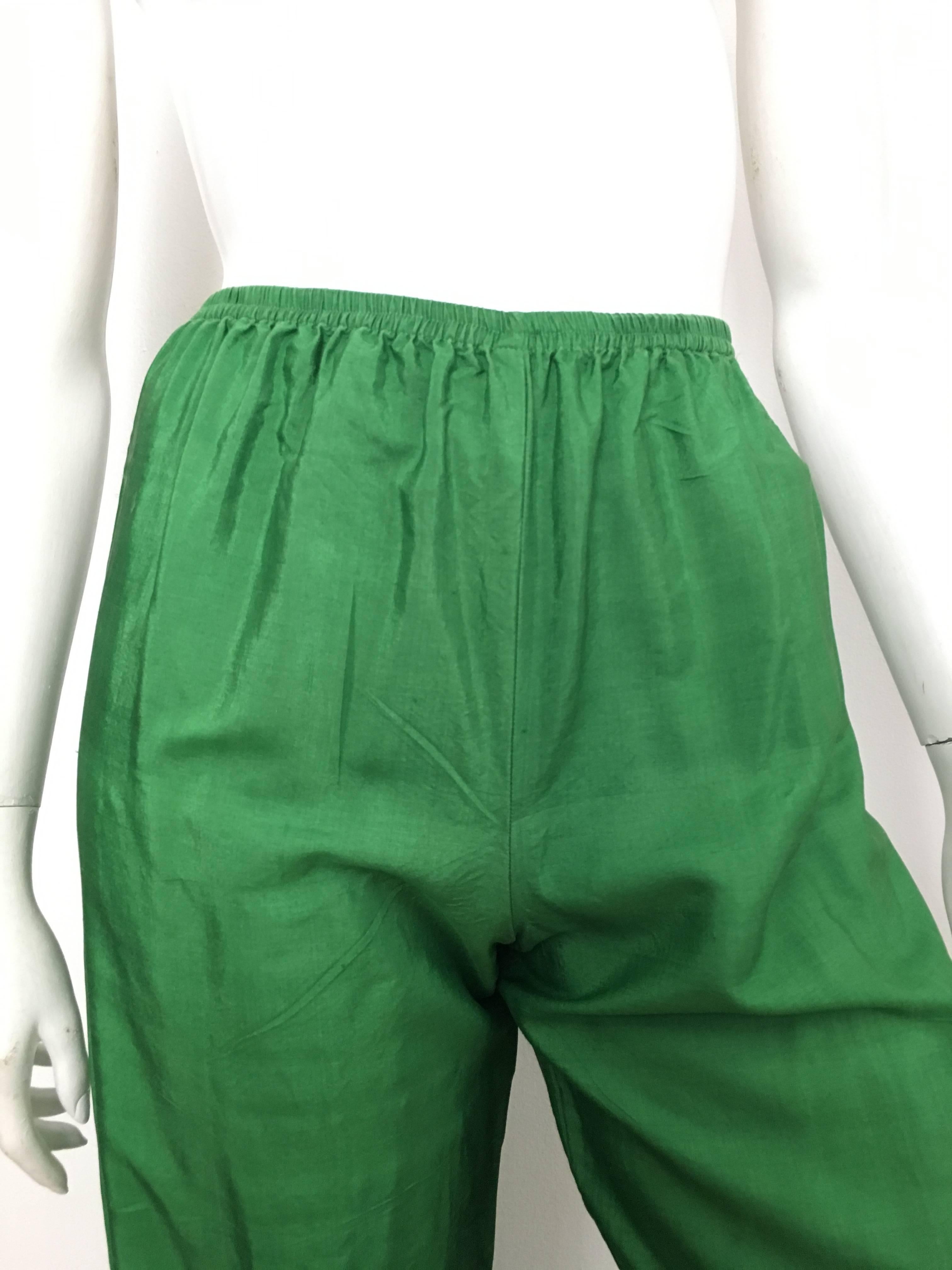 Saint Laurent Rive Gauche 1970s green silk pants with elastic waist band is a French size 36 and fits an USA size 4.  These pants were purchased in Paris at the YSL boutique from my client who was there for a modeling assignment during the late