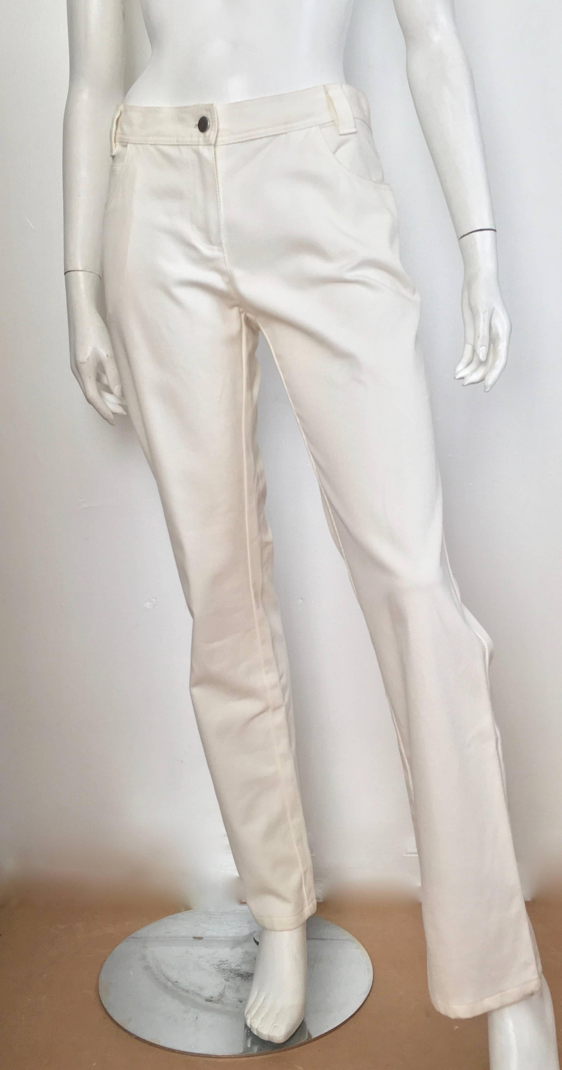 Valentino white cotton twill casual pants with pockets and rhinestone 'V' logo on back pocket is a size 8.  Ladies the waist on these pants are 32.1/2