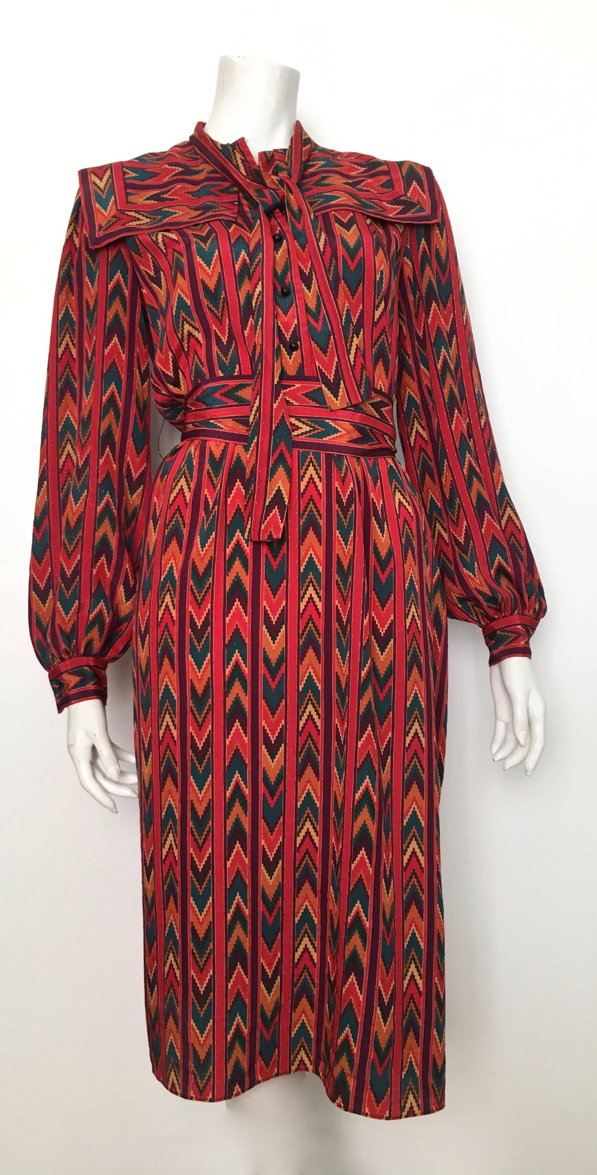 Molly Parnis Studio 1980s native American print long sleeve dress with sash tie belt is labeled a vintage size 4 but fits more like a modern day size 10.  The waist on this dress is 34