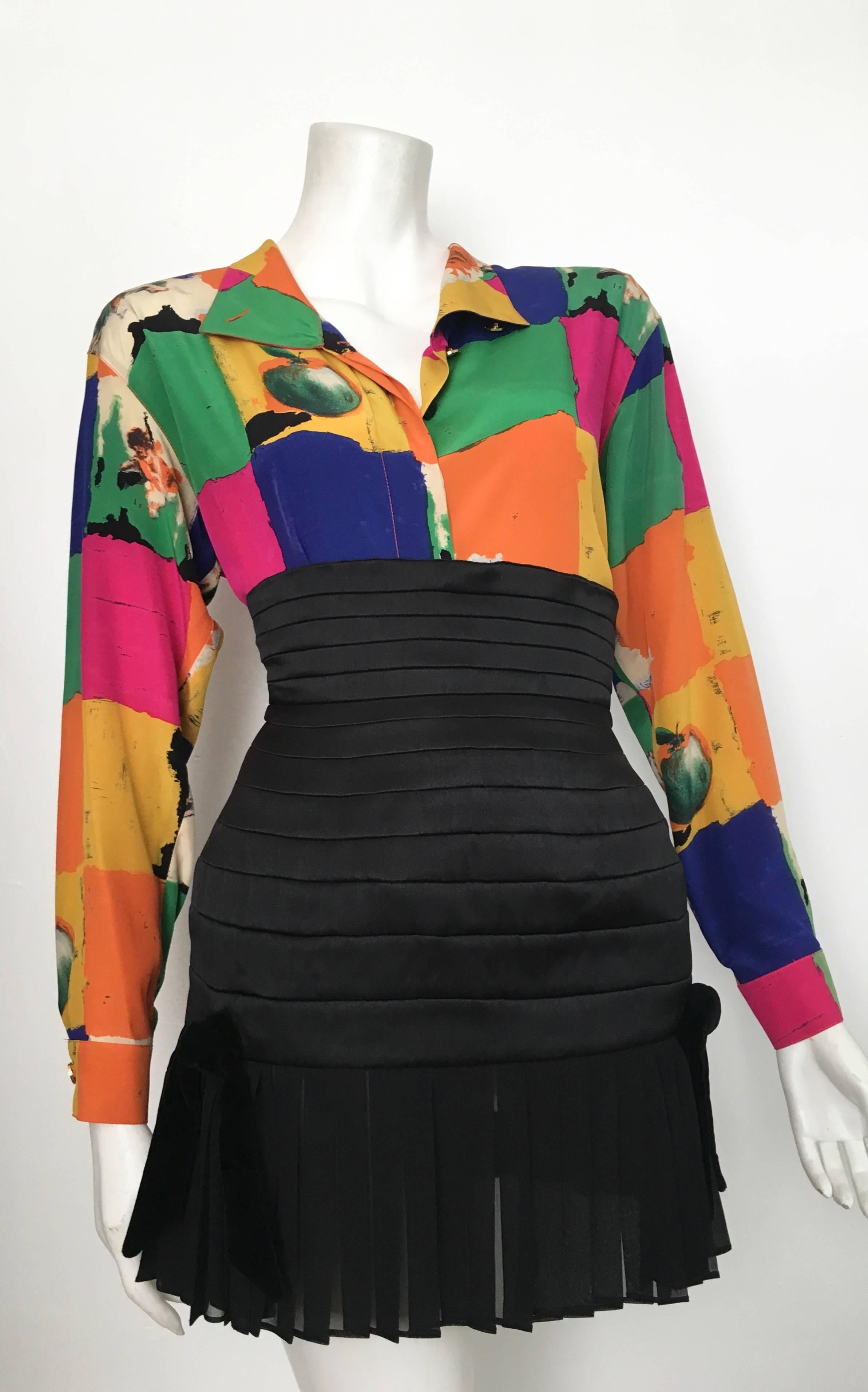 Emanuel Ungaro Parallele Paris 1980s colorful silk block pattern with cherubs & fruit images is a long sleeve abstract blouse size 4 but will also fit a size 6. This blouse is cut to be big and flowing. There are shoulder pads inside that can