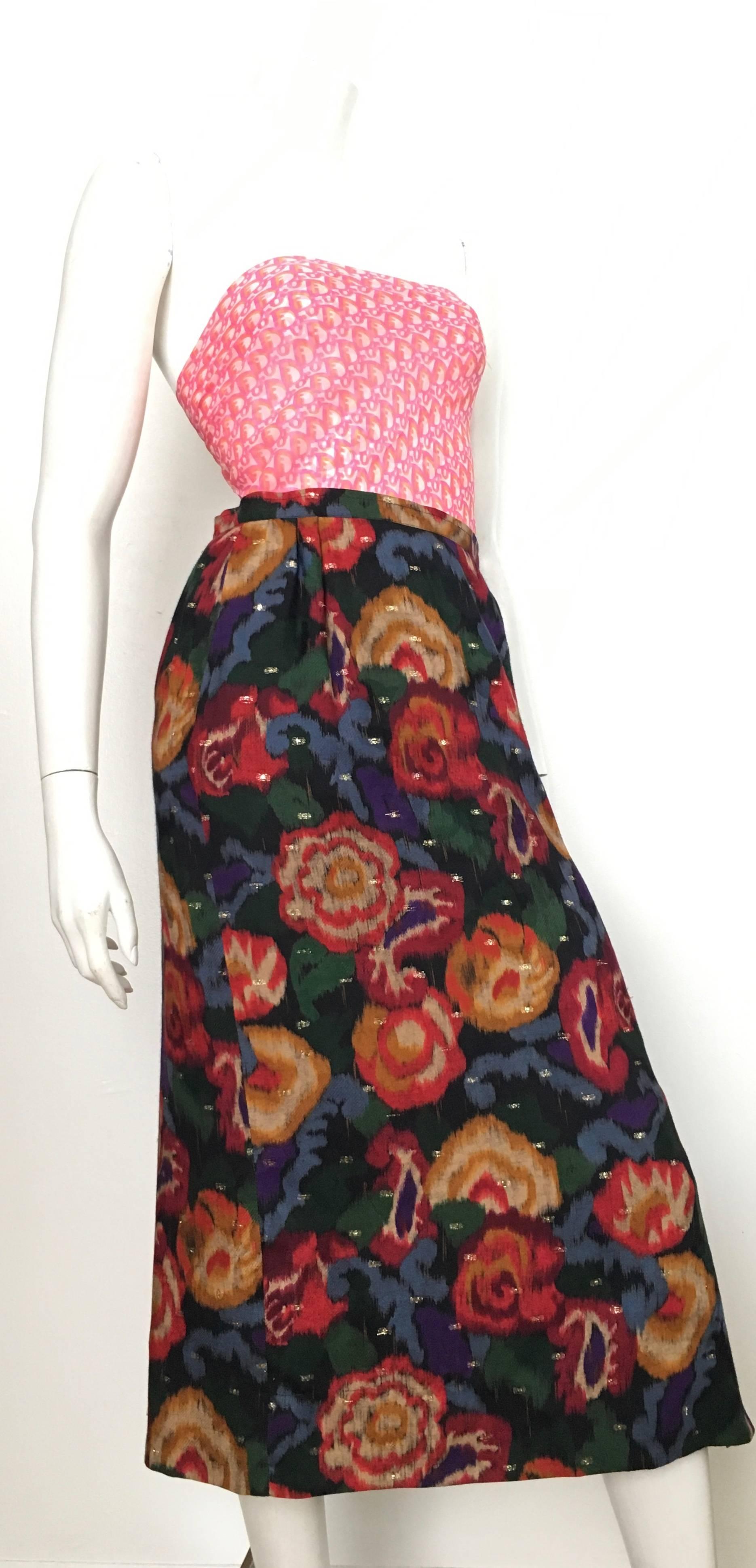 Emanuel Ungaro Parallele Paris 1980s wool / silk long floral skirt with gold metal fabric threads running throughout the pattern is labeled a size 8 but fits more like a USA size 4 / 6. The waist on this skirt is 27
