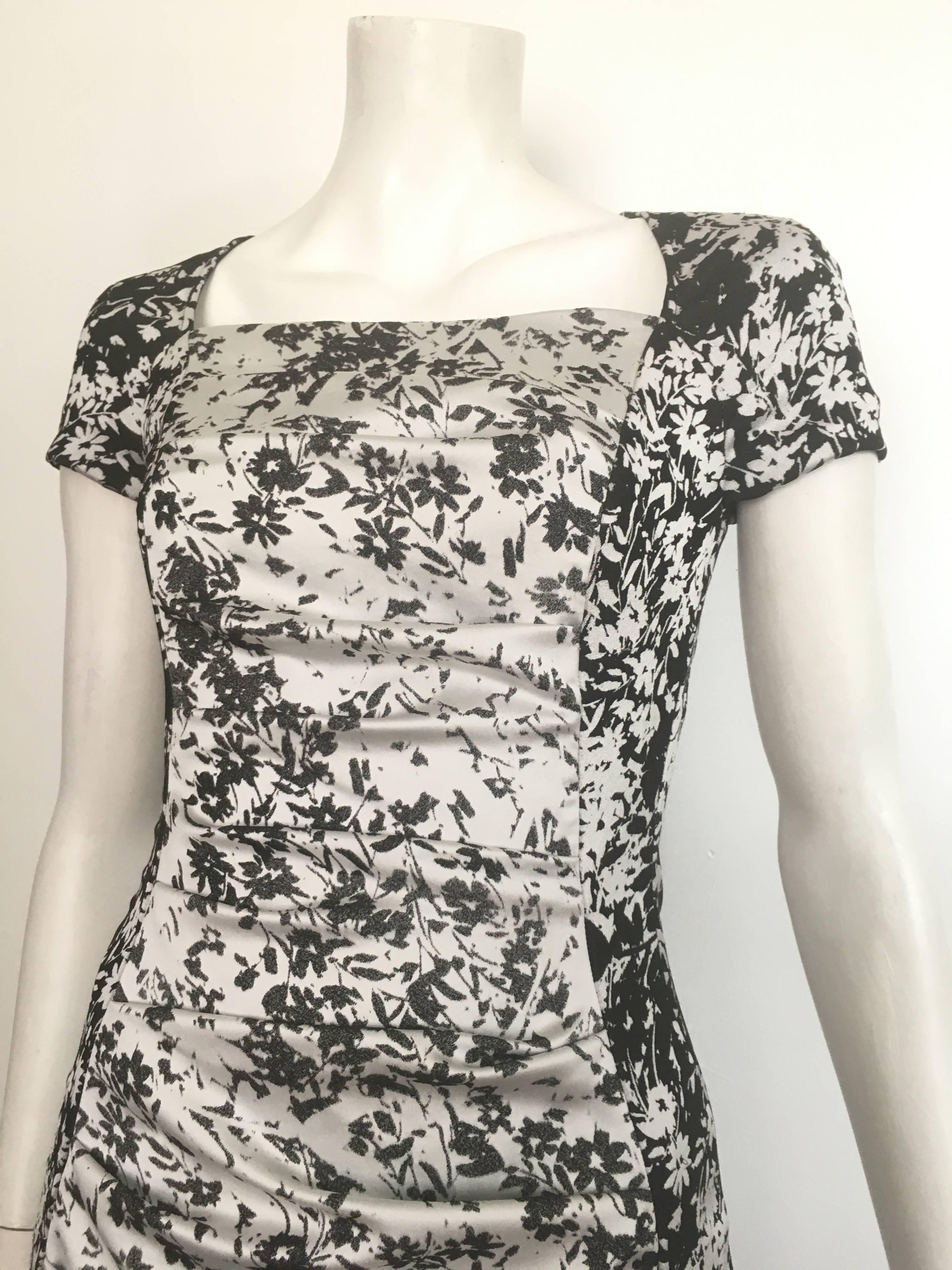 Talbot Runhof Pret black & white floral pattern short sleeve day / evening casual dress is labeled a size 6.  The waist on this dress is 28