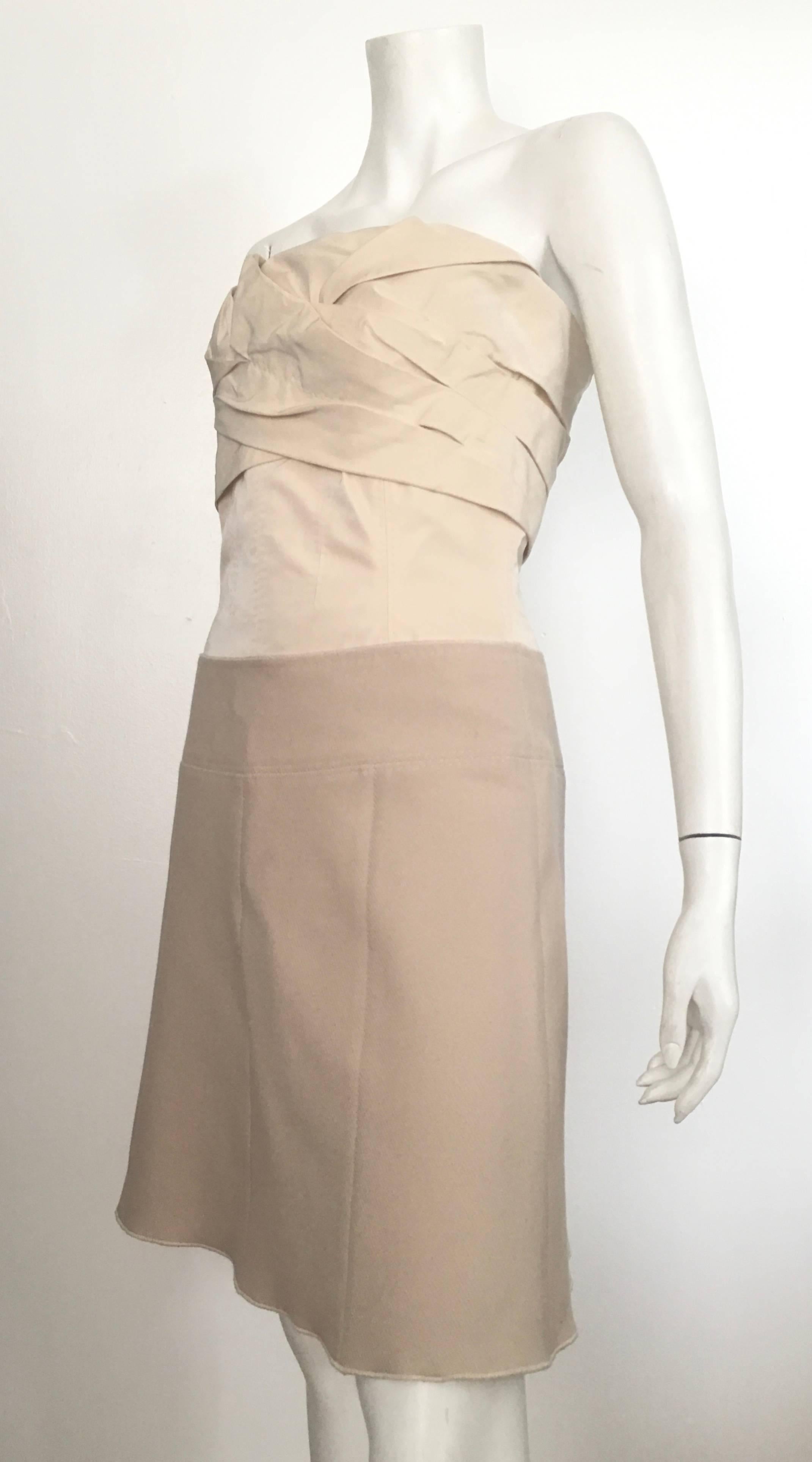 Louis Vuitton cream strapless mini dress featuring folding detail at bust, corset bodice and bronze-tone zip closure at back. French size 38 - USA size 6.  The waist is 29. 1/2