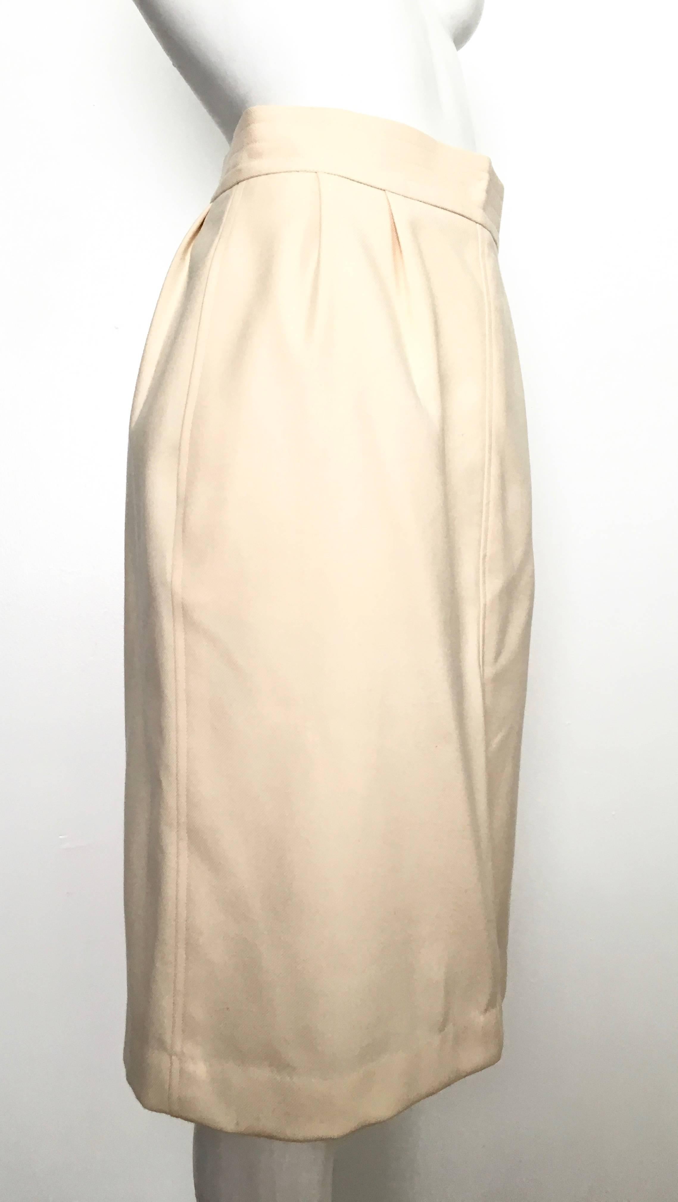 Saint Laurent Rive Gauche 1980s wool cream pencil skirt with pockets is a French size 40 and fits like a 4/6. The waist on this skirt is 27