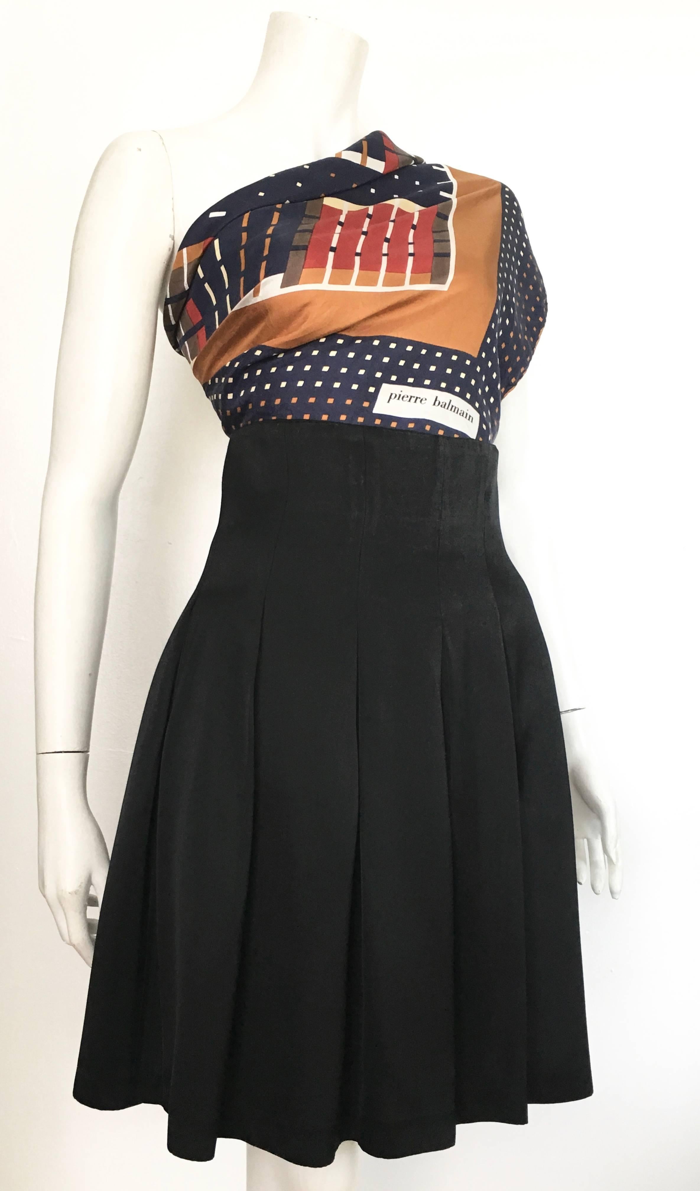 Patrick Kelly Paris 1980s black pleated skirt is a size 6.  The waist on this skirt is 30