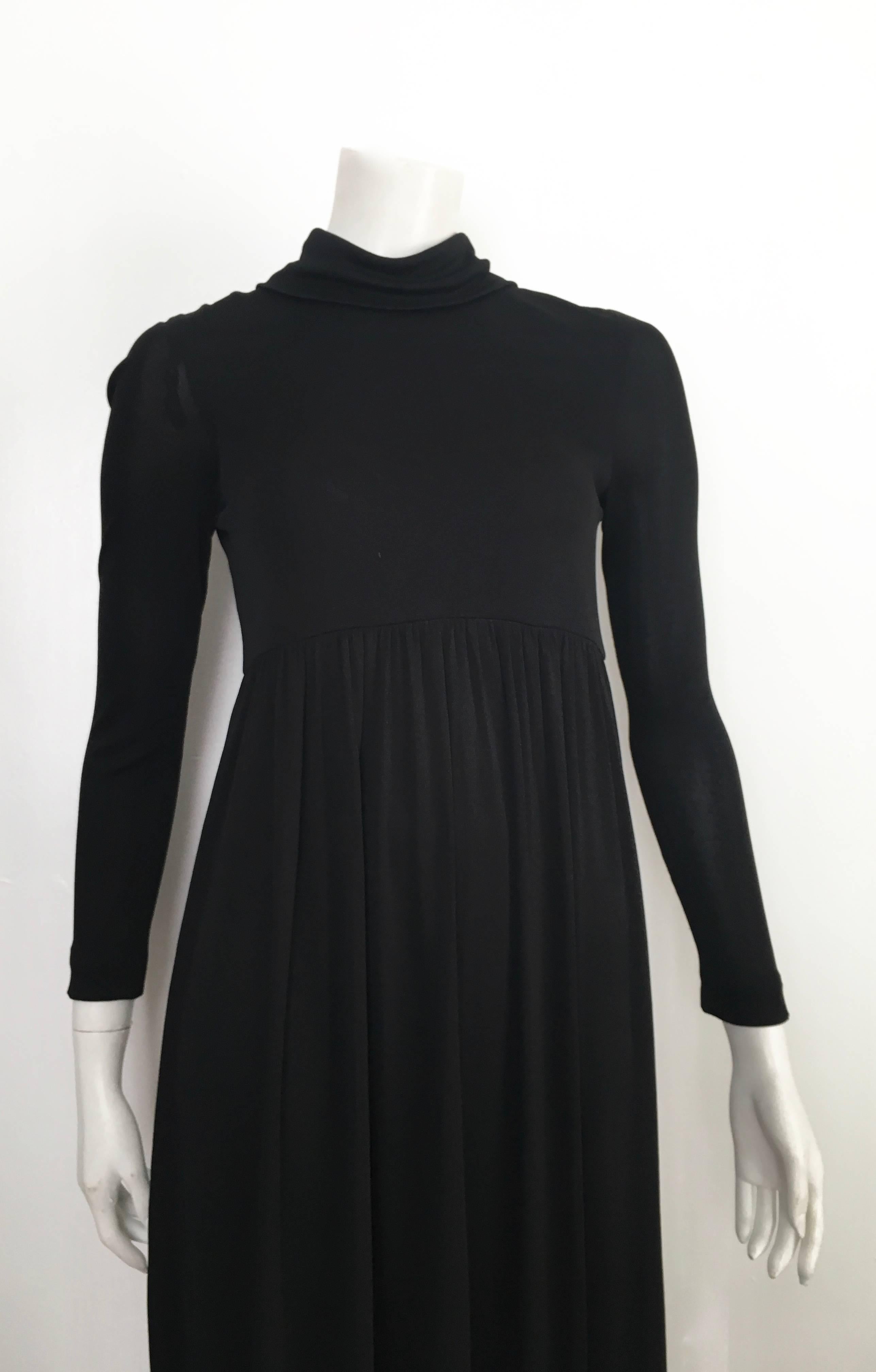 Joseph Magnin 1960s black jersey maxi long sleeve dress is labeled a vintage size 10 but fits like a size 4.  The waist on this dress is 28
