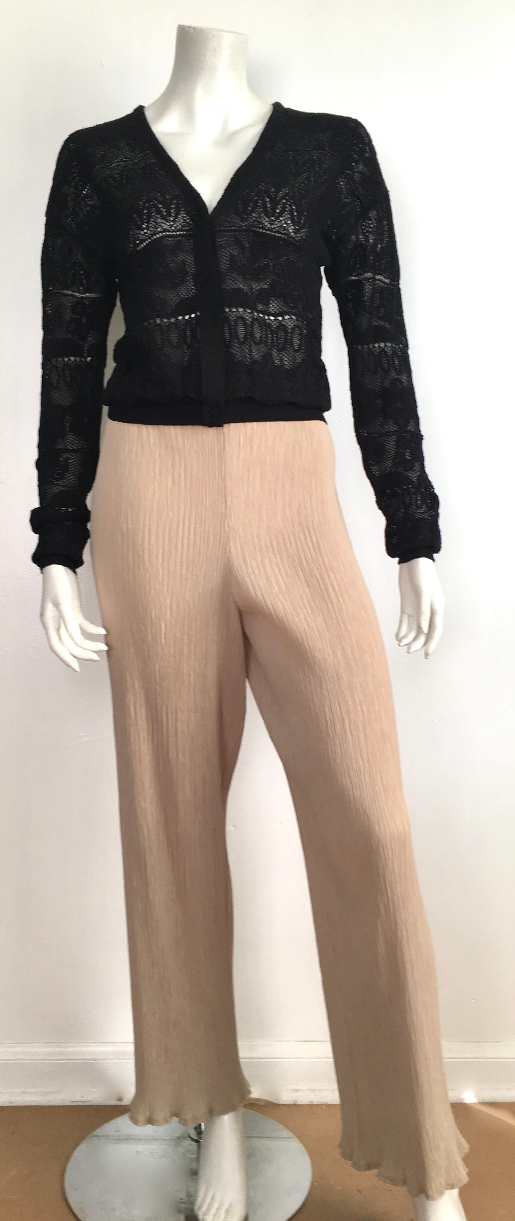 Lanvin 125 black lace knit snap button cardigan is a size small and will fit a size 4 perfectly. Matilda the Mannequin is a size 4 and this Lanvin piece fits her beautifully. There are four snap buttons.  I styled Matilda wearing a vintage Dior