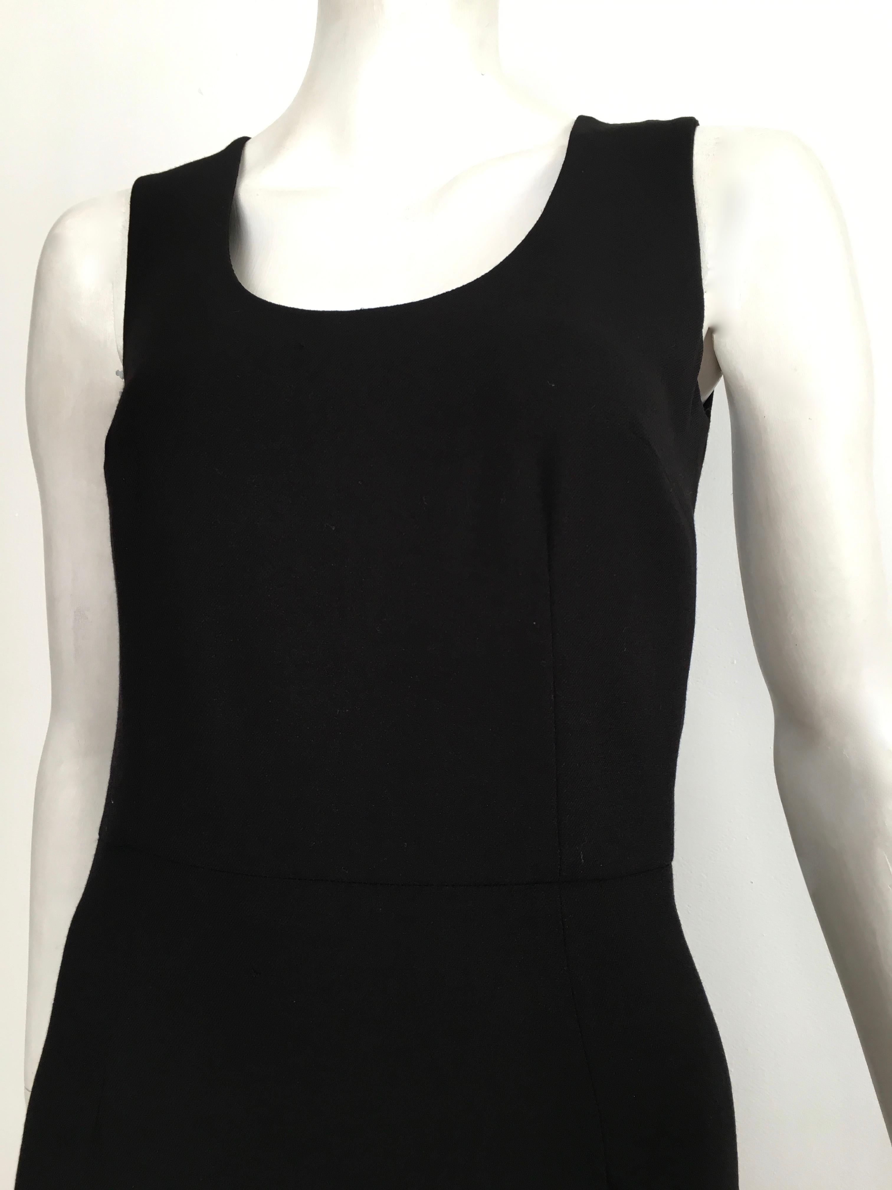 Dolce & Gabbana 1990s black wool sheath sleeveless dress is an Italian size 40 and will fit an USA size 4.  The waist is 28