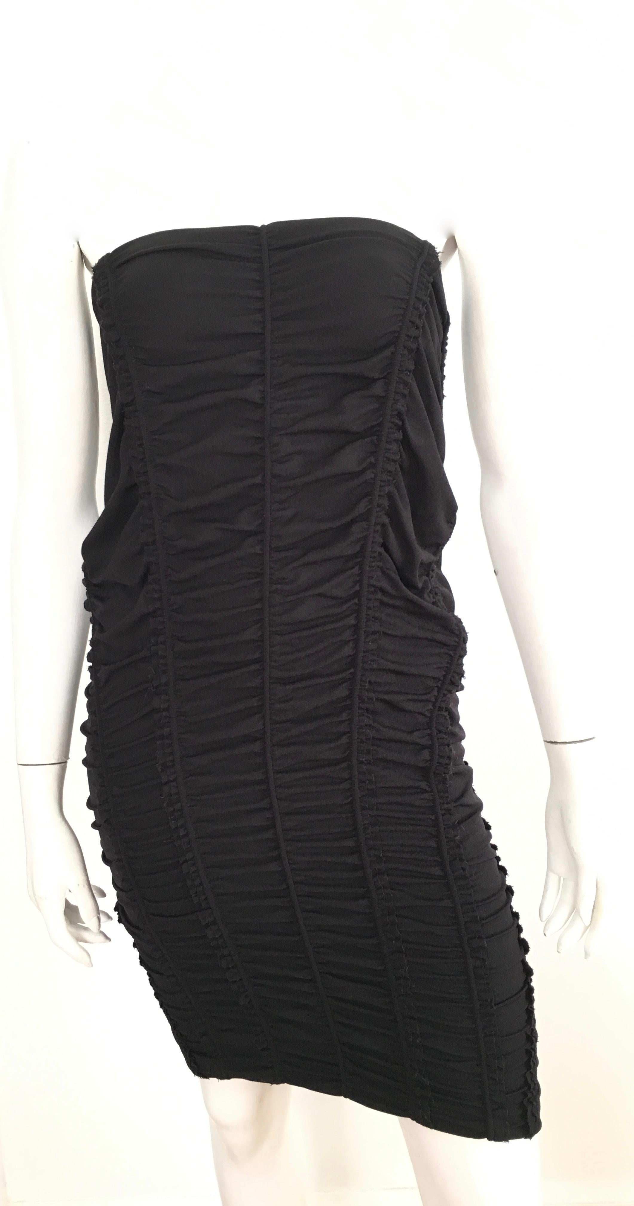 Donna Karan New York 2000s black parachute dress is labeled a size 8 but fits more like a size 6. There is an elastic band around the top part of dress. Italian fabric is wool, nylon & spandex.  This show stopper dress is just stunning, it has the