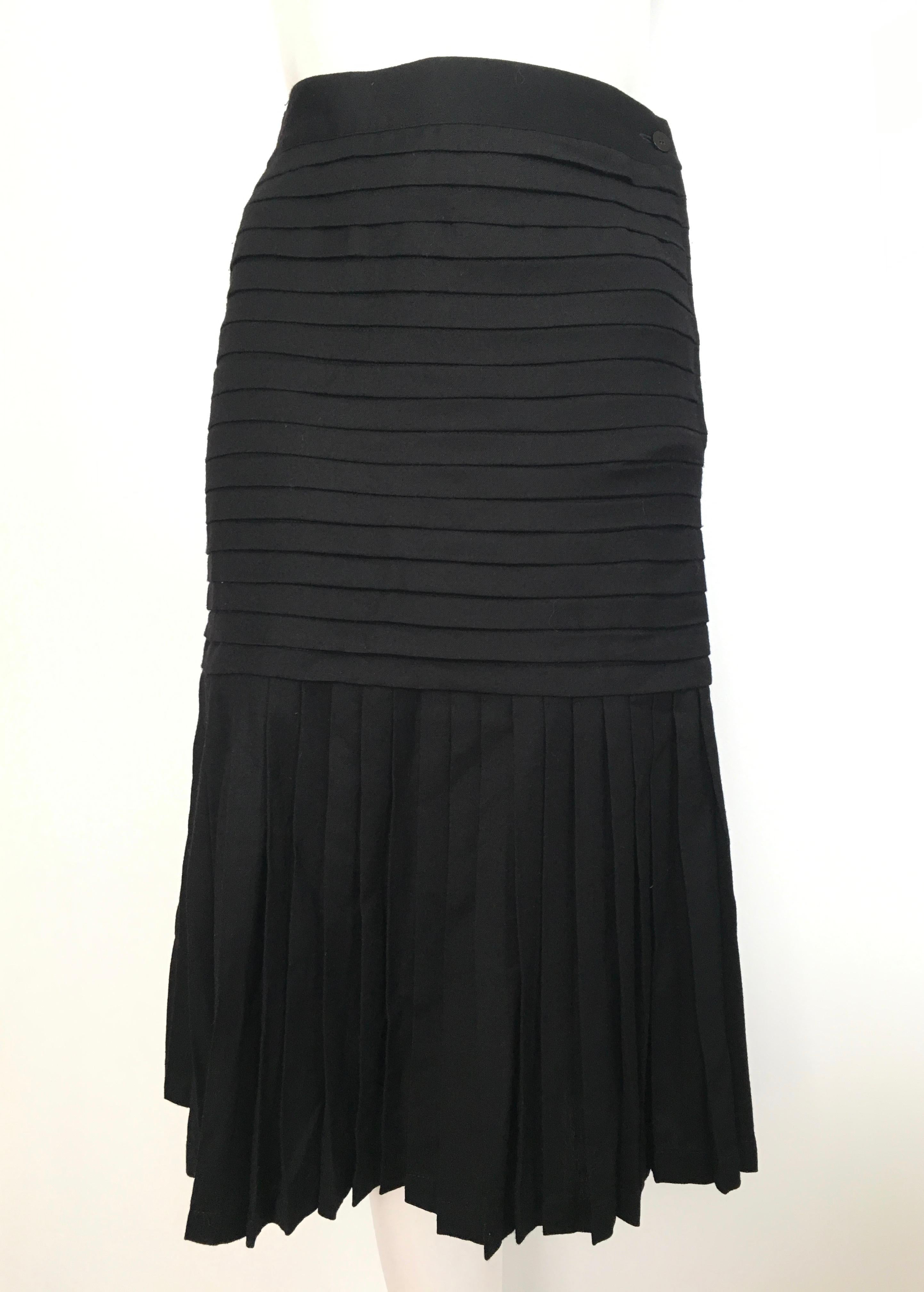 Genny black wool pleated skirt is labeled a size 8 but fits more like a size 6.  The waist is 27