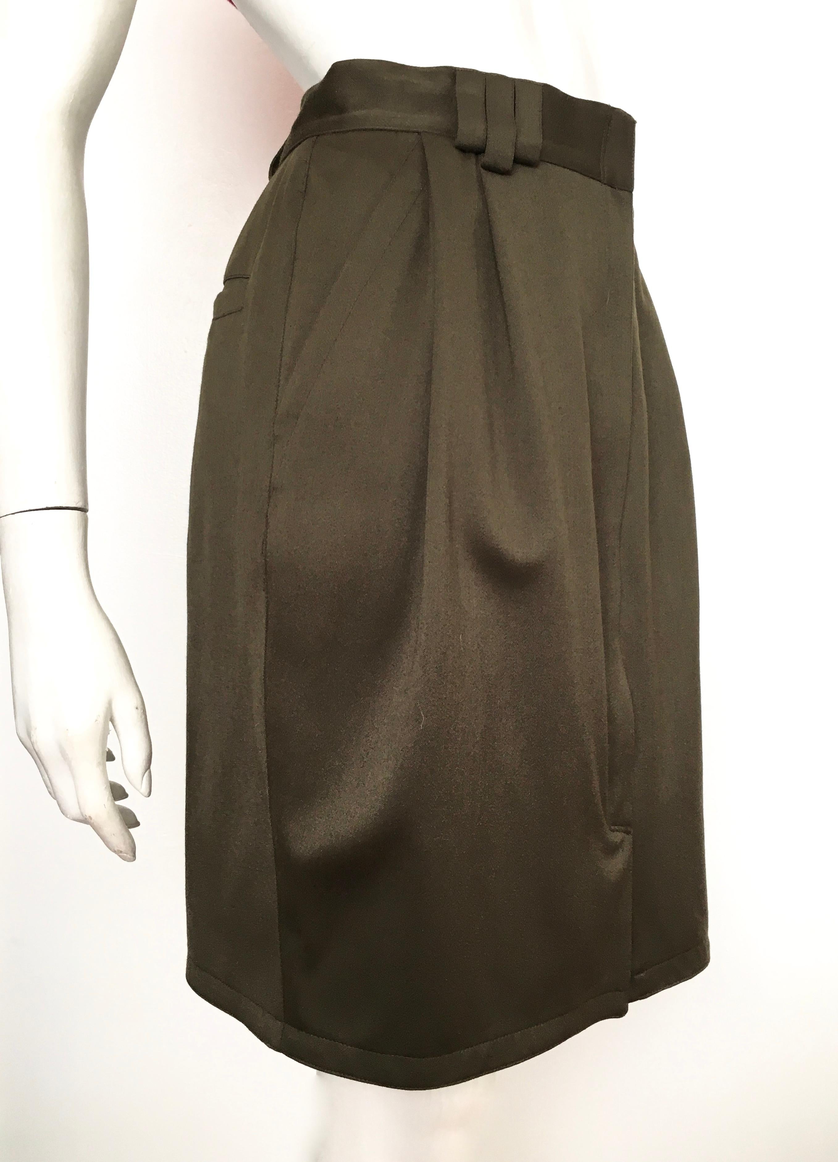 Gianni Versace 1980s olive green wool skirt with pockets is an Italian size 44 and fits a size 6.  The waist is 28. 1/2