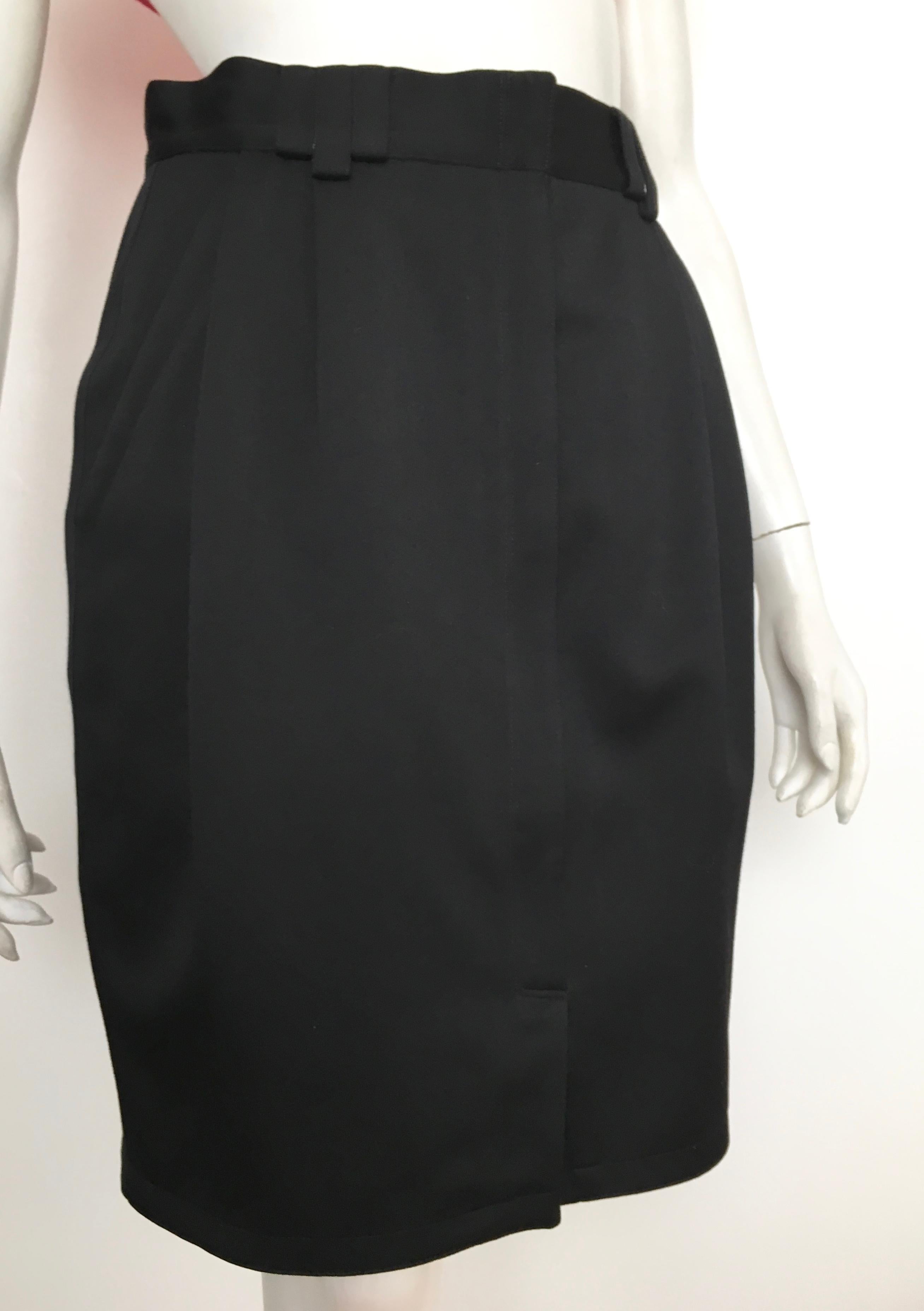 Gianni Versace 1980s black wool skirt with pockets is an Italian size 42 and fits like a size 4. The waist on this skirt is 28