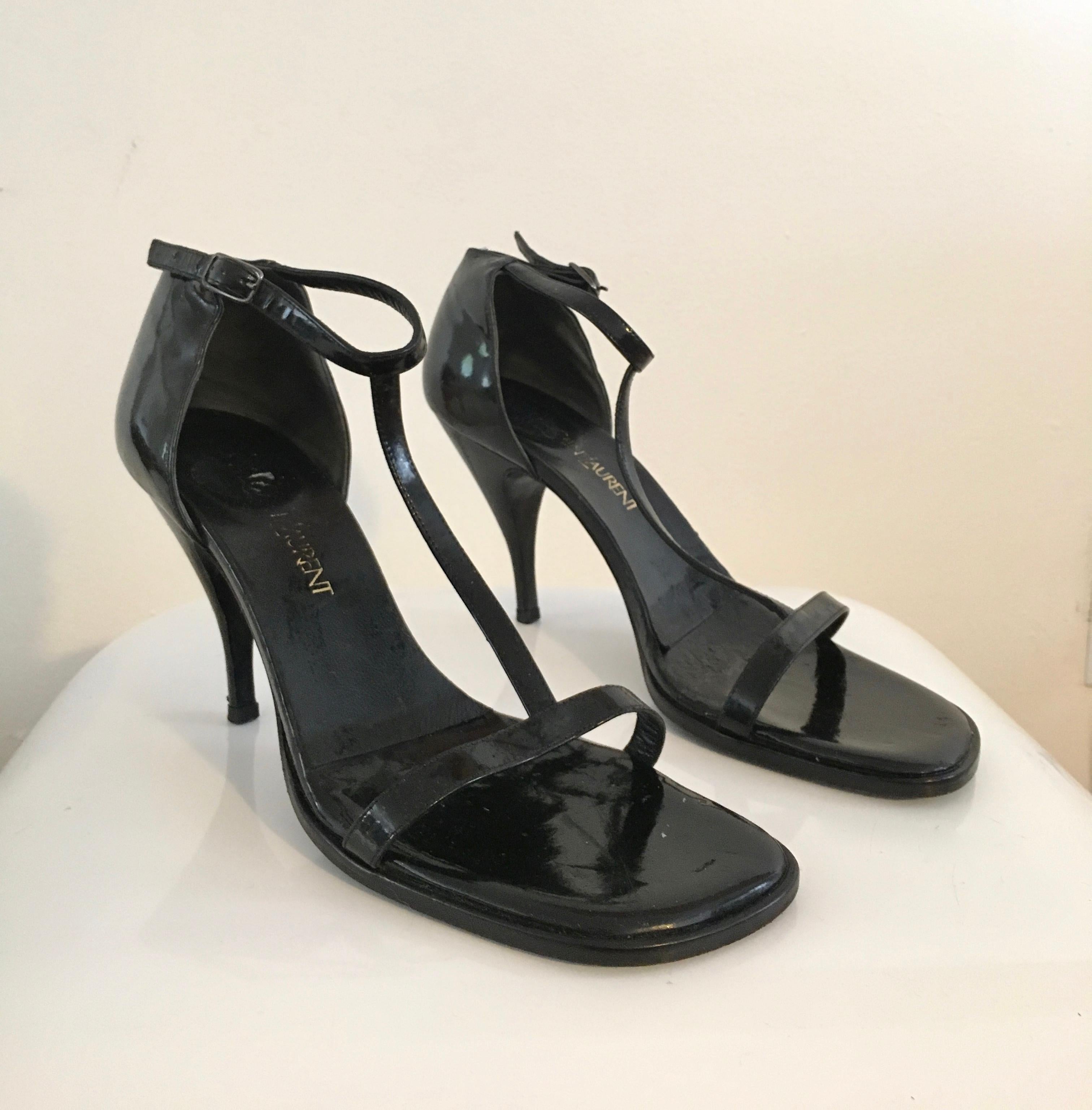 Yves Saint Laurent black patent leather high heel shoes are a size 8. 
3. 1/2