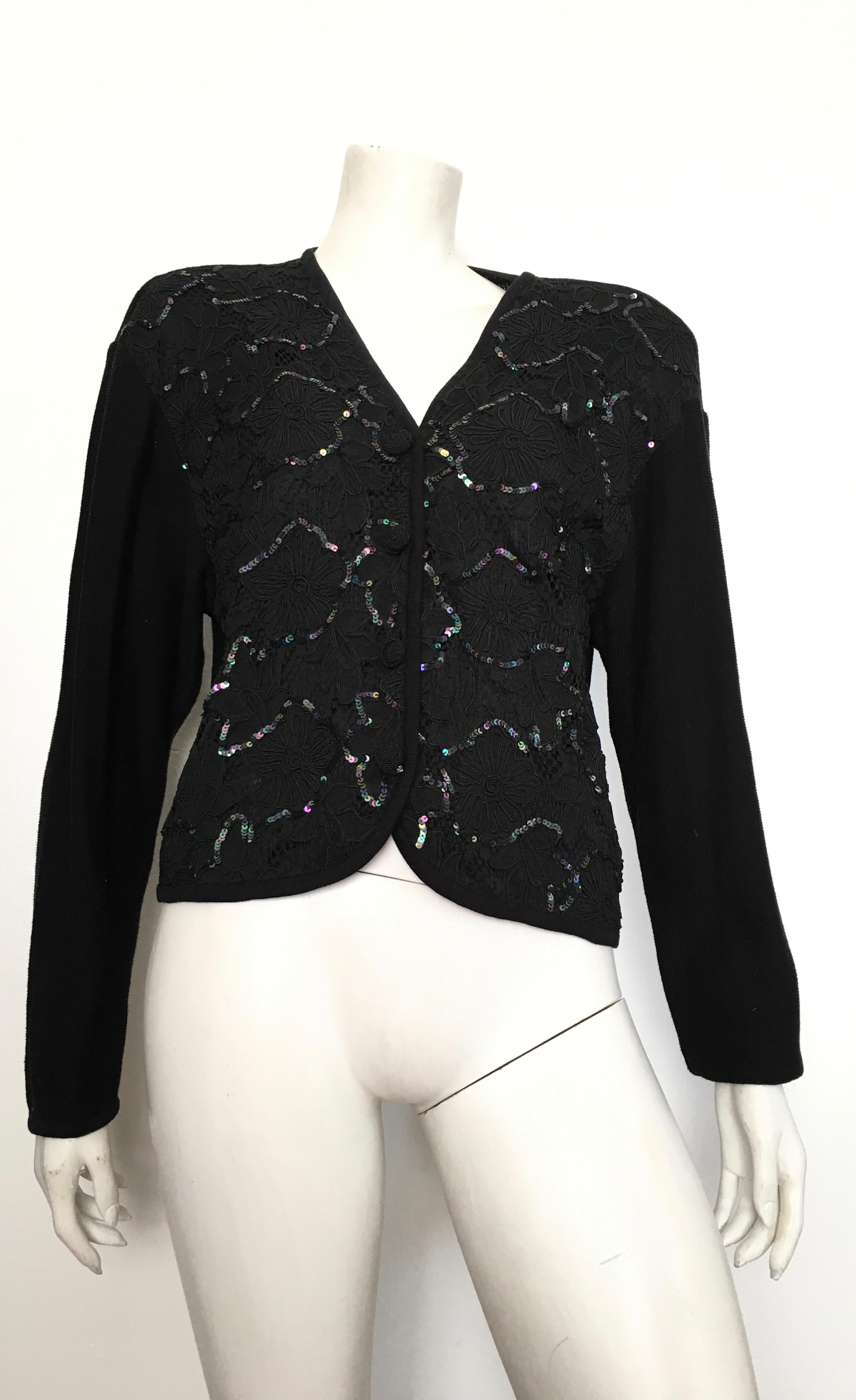 Emanuel Ungaro ter 1990s black knit with sequins cardigan is a size large. Cardigan has shoulder pads that can be removed if so desired.  This is a gorgeous cardigan fit for any evening occasion. Cardigan is not lined.
Measurements are:
46