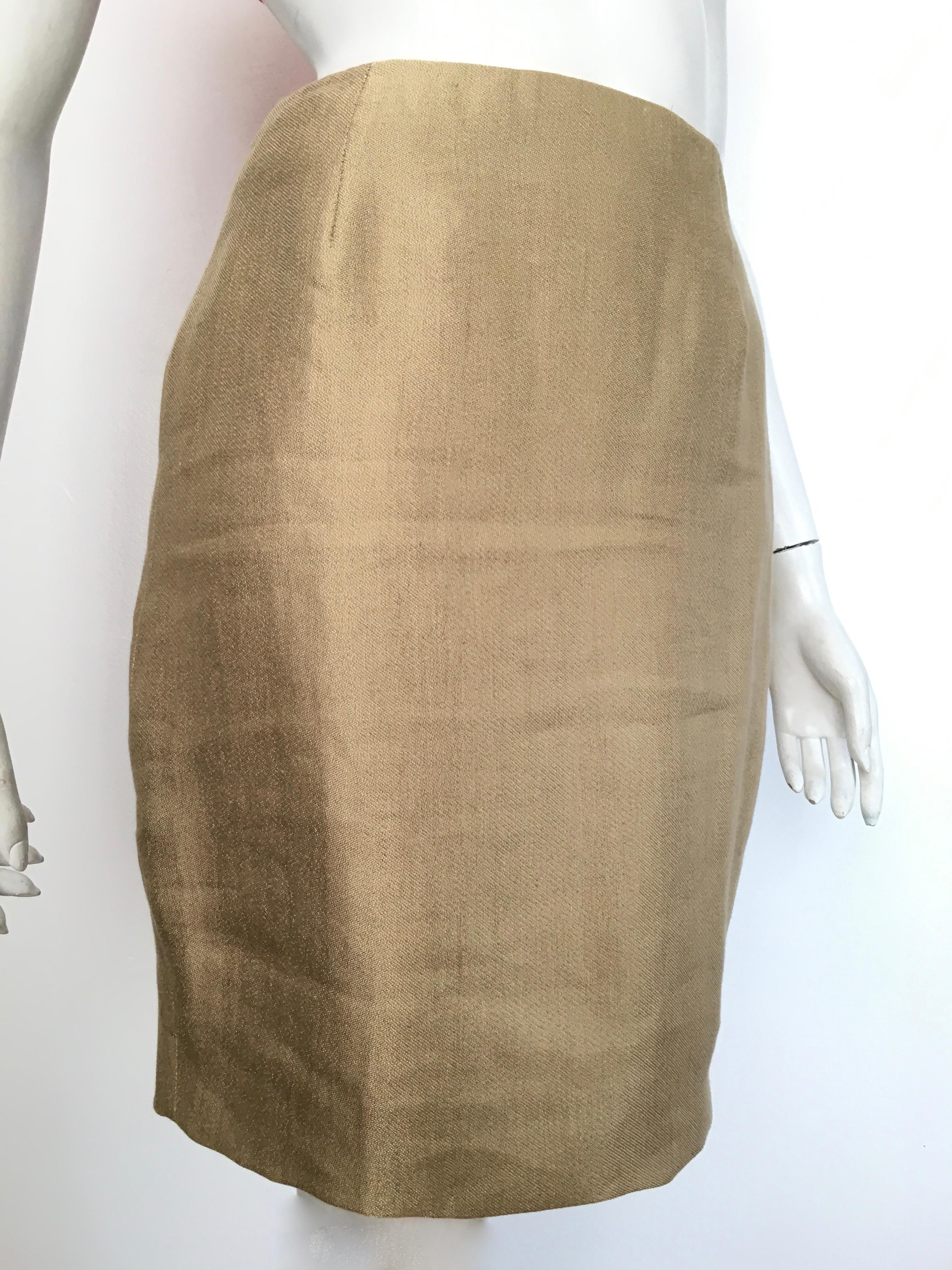 Donna Karan New York 1990s gold short pencil skirt is a size 4.  The waist on this skirt is 27. 1/2
