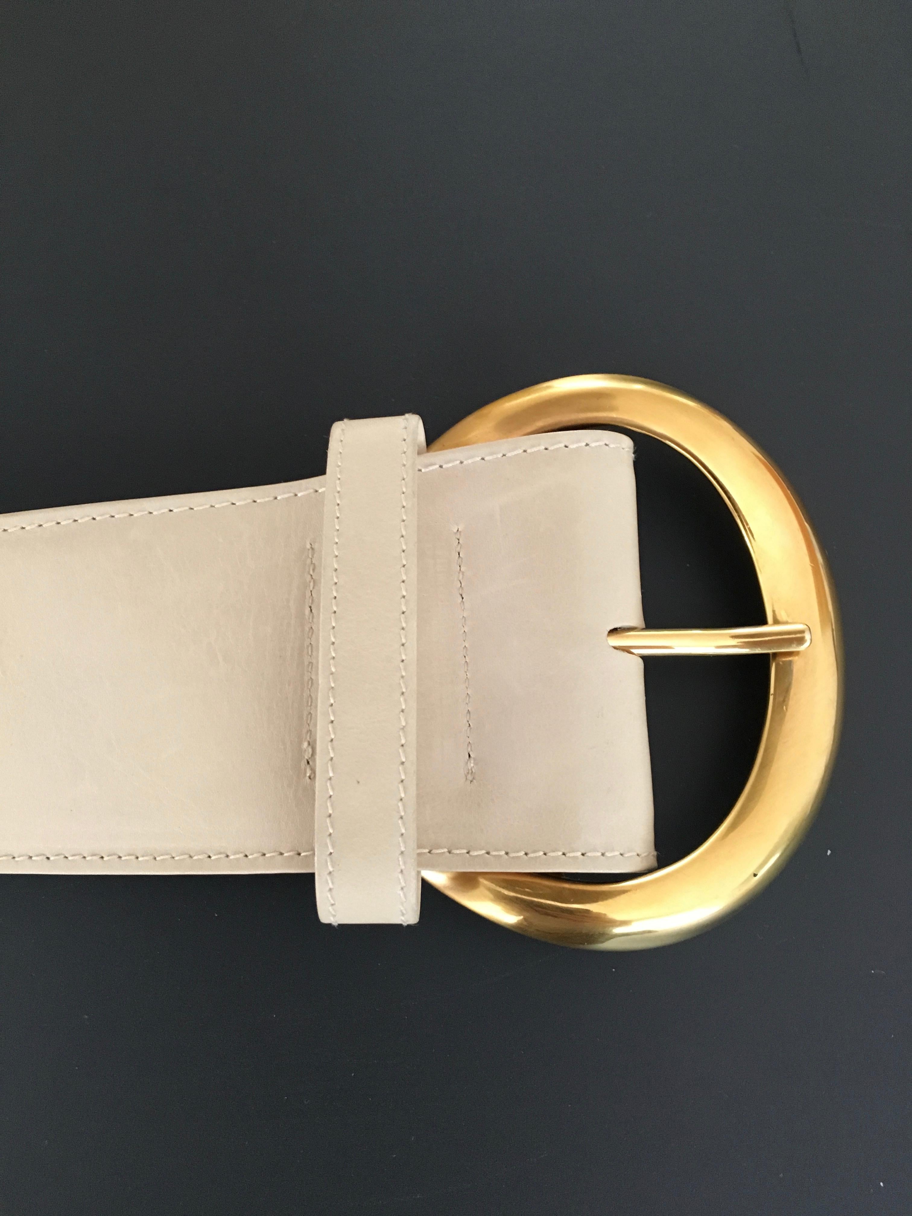 Donna Karan New York 1990s cream wide leather belt with big organic shape brass buckle is a size small.  Made in Italy. This iconic belt by Donna Karan is sophisticated and  always in style. Donna Karan's designs were always so minimal, so clean, so