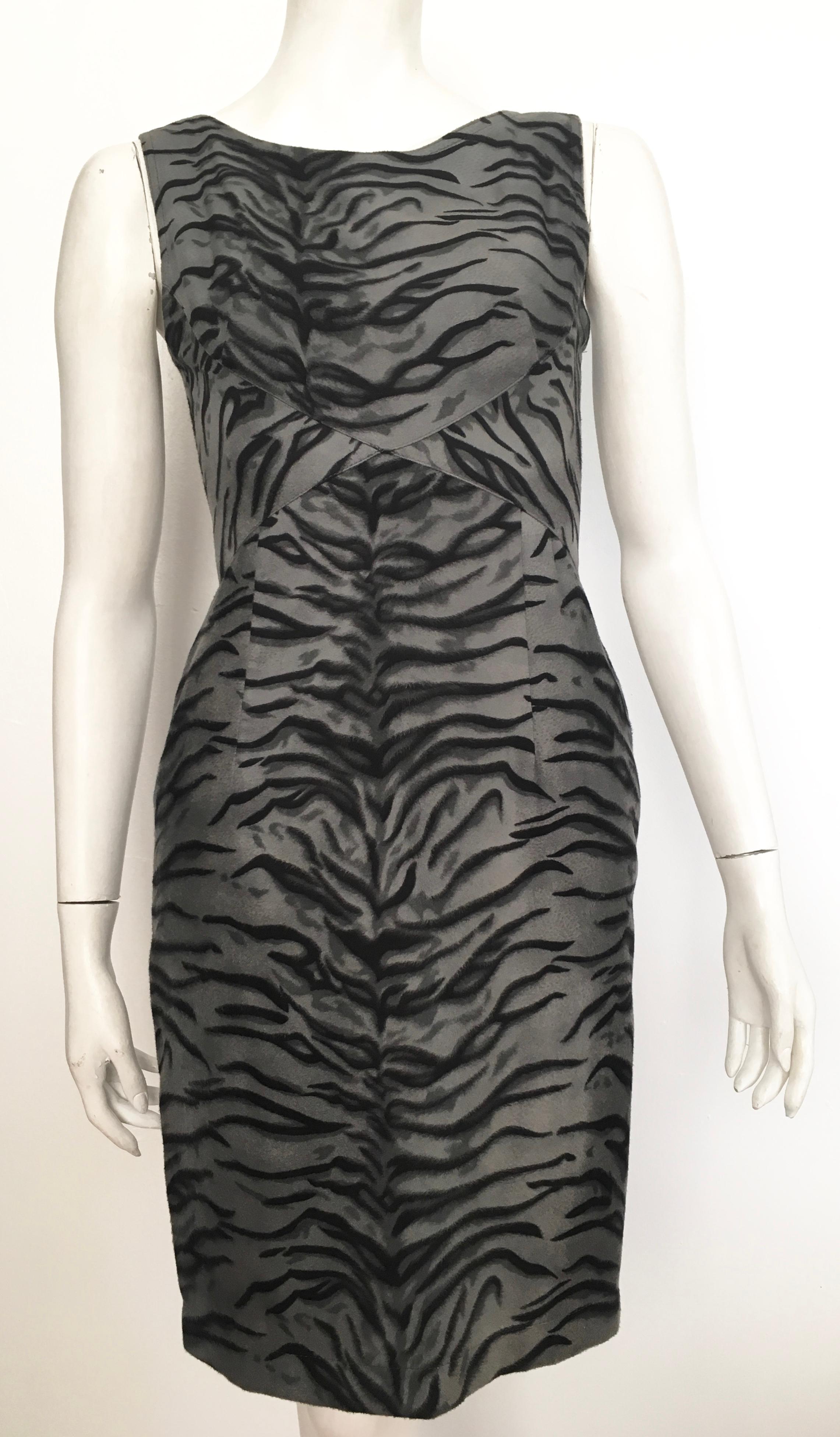 Moschino gray tiger print sleeveless dress is labeled a USA size 8 but it is a size 4.  The waist on this dress is 27. 1/2