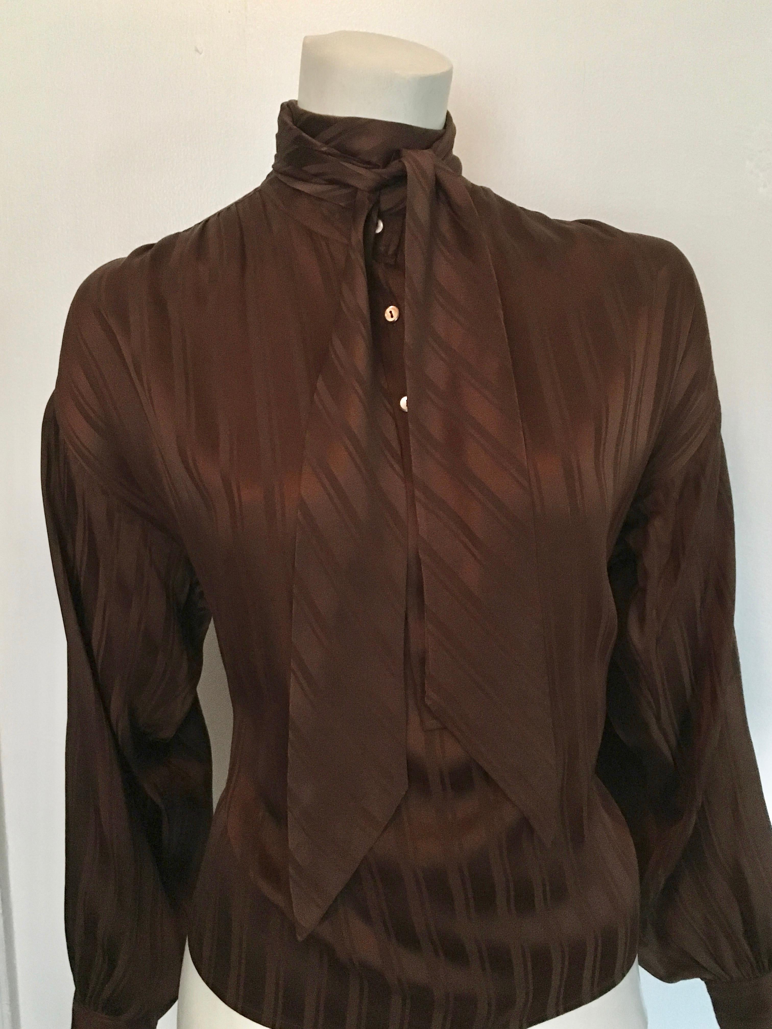 Yves Saint Laurent Rive Gauche1970s brown silk blouse with tie is a size large.  This blouse was designed to be overflowing and blousy and will fit sizes 6, 8, 10 but you be the judge of that. Classic striped pattern with tie, this blouse will have
