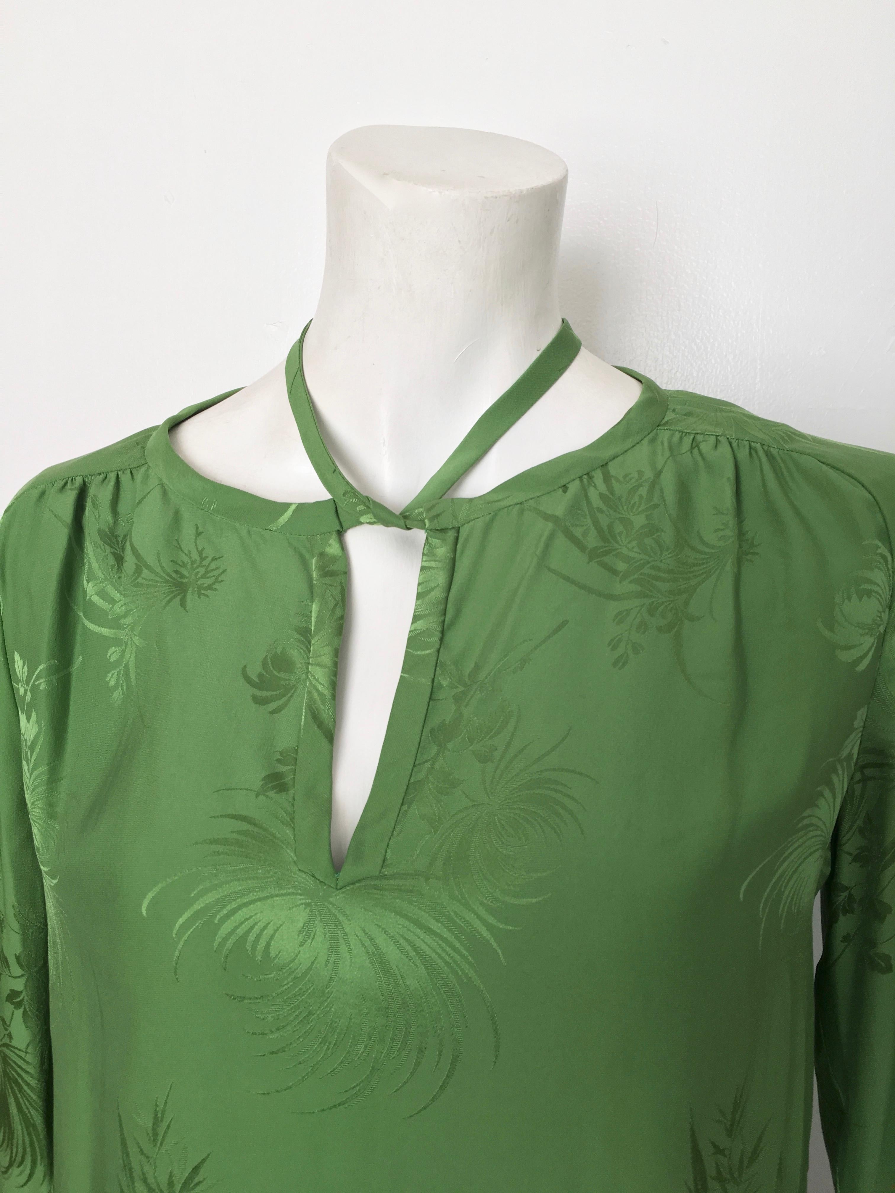 Malcolm Starr 1970s green silk long sleeve blouse with neck tie is labeled size 10 but fits more like an US size 6/8.  Gorgeous bamboo leaf pattern on this blouse makes it timeless.  One sleeve button fabric is thin and in need of repair.  Any