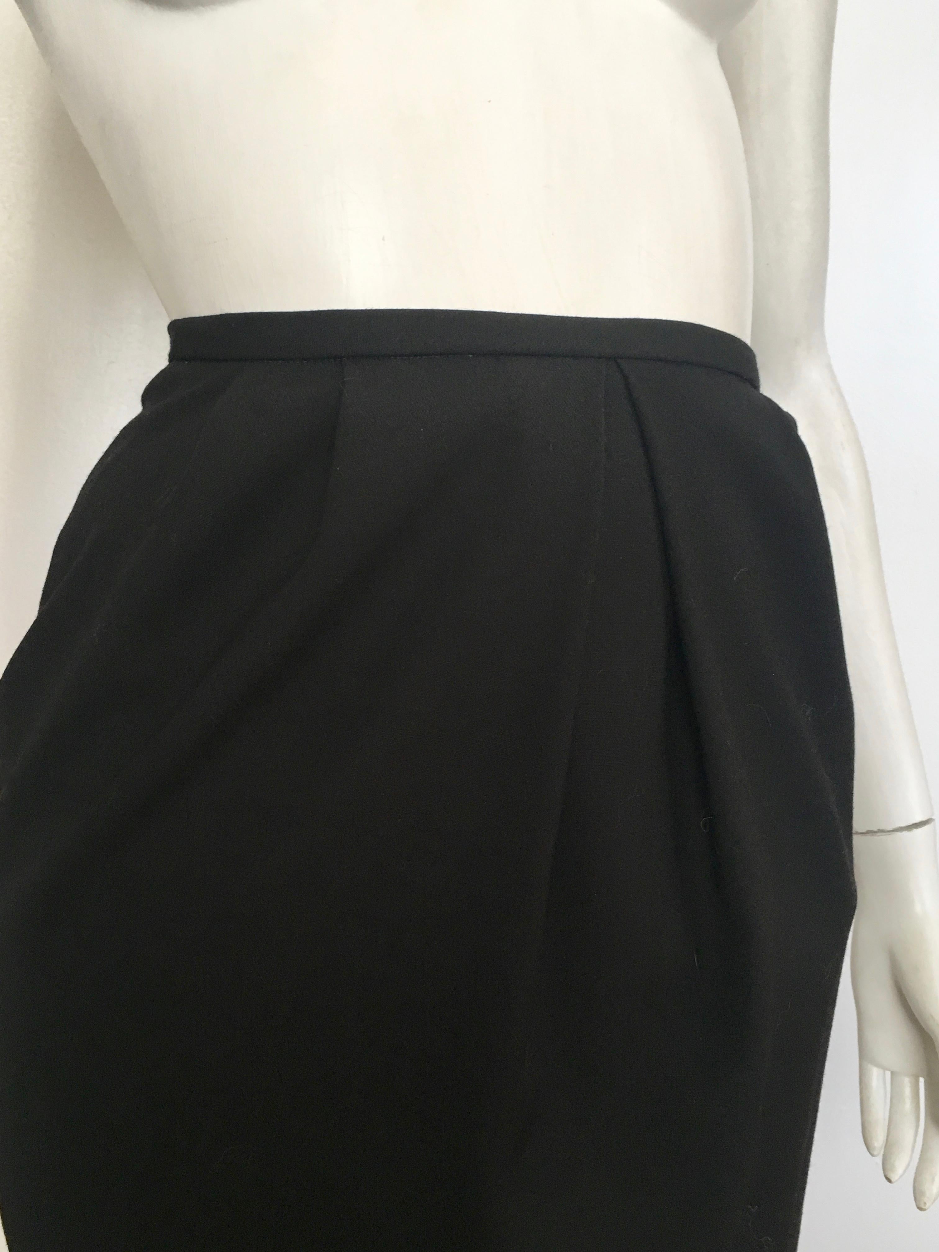 Gianfranco Ferre 1980s black wool sexy short skirt is labeled a size 6 but fits like a size 0.  The waist on this skirt is 23. 3/4