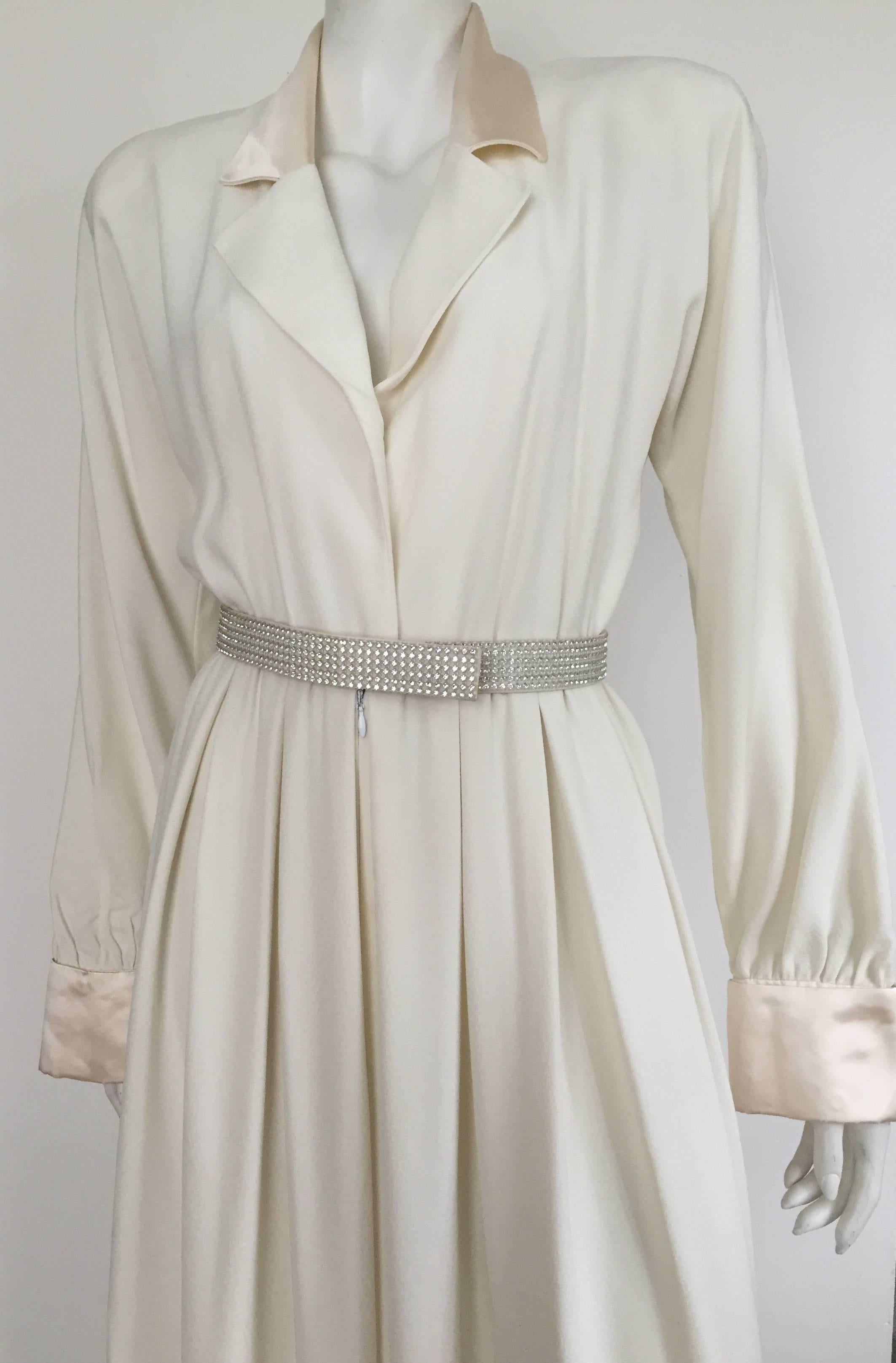 Carolyne Roehm 1980s elegant cream wool crepe tuxedo jumpsuit with rhinestone belt size 4. Silk collar - lapel  - cuff give this very chic jumpsuit its sophisticated look. Shoulder pads and is completely lined. 
Someone call Joan Crawford and let