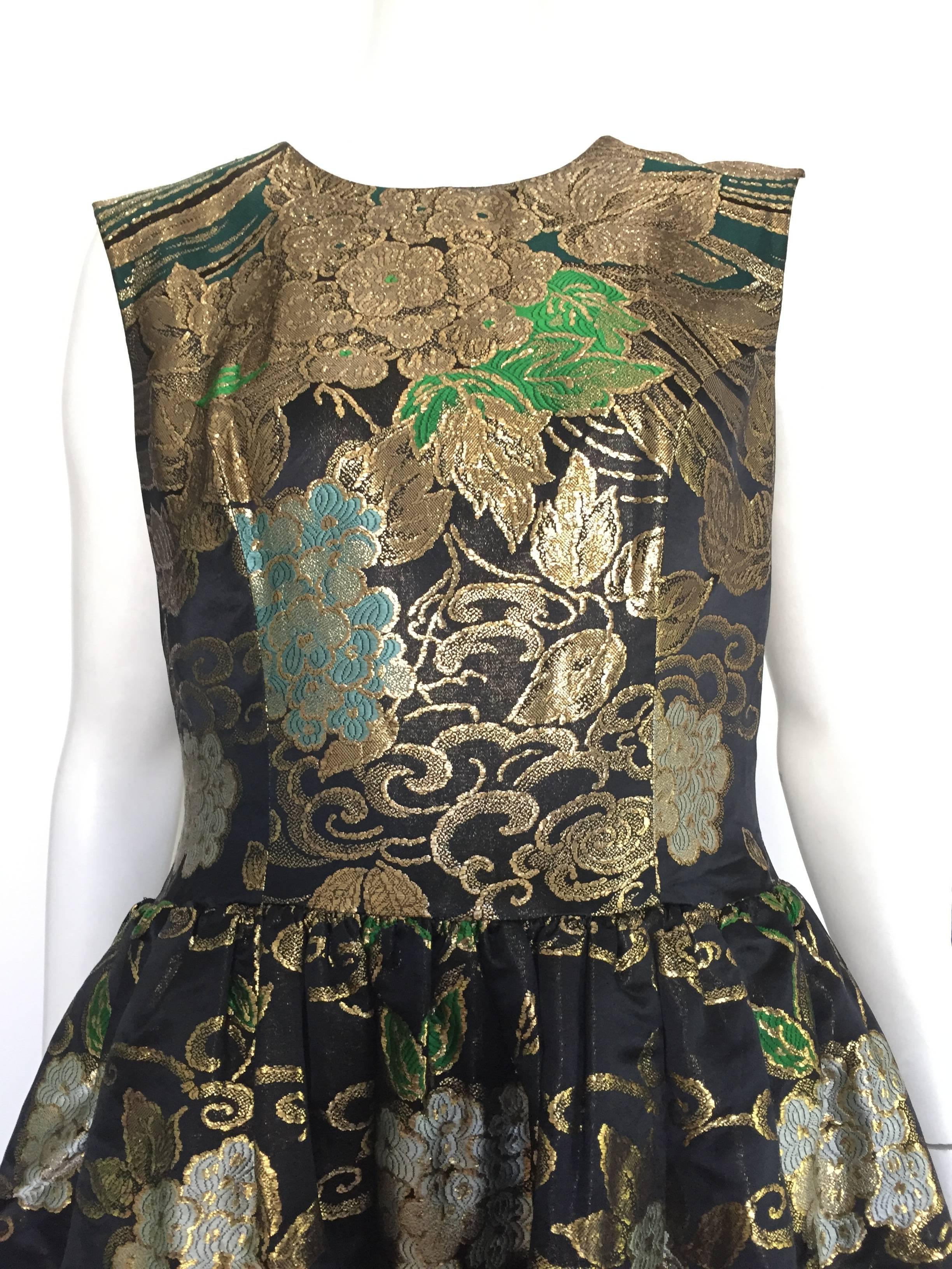 Gustave Tassell 1956 black & gold brocade evening dress and is a size 12 but please see & use the measurements below so that you can measure your waist to make sure this is your size and will fit the way Gustave wanted it to... Dress is silk lined. 