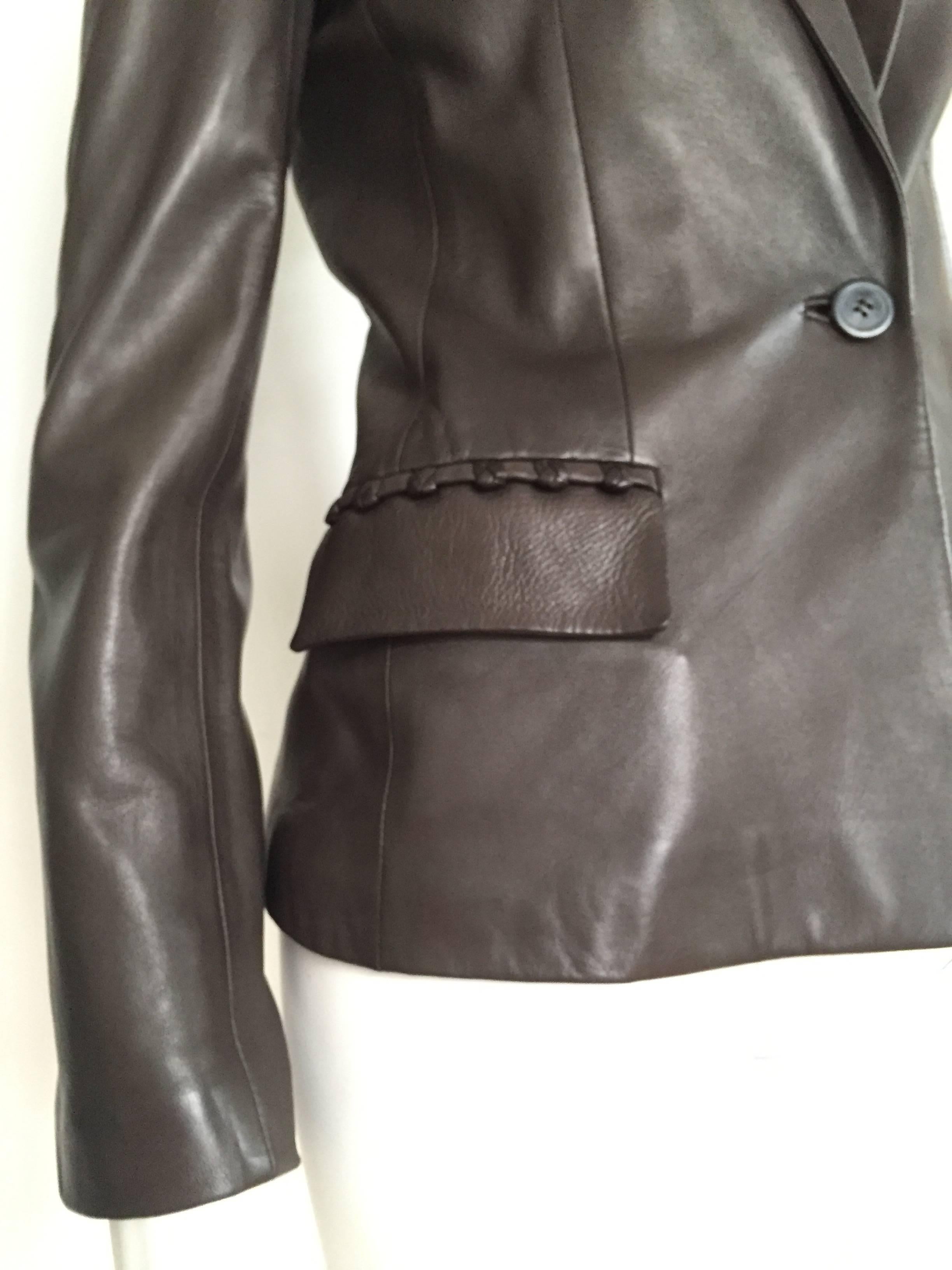 Yves Saint Laurent Rive Gauche by Tom Ford 2002 chocolate leather runway jacket is a Italian size 38 and a USA size 4 ( Please see & use the measurements below so that you can properly measure your body to make certain that this will fit the way Tom