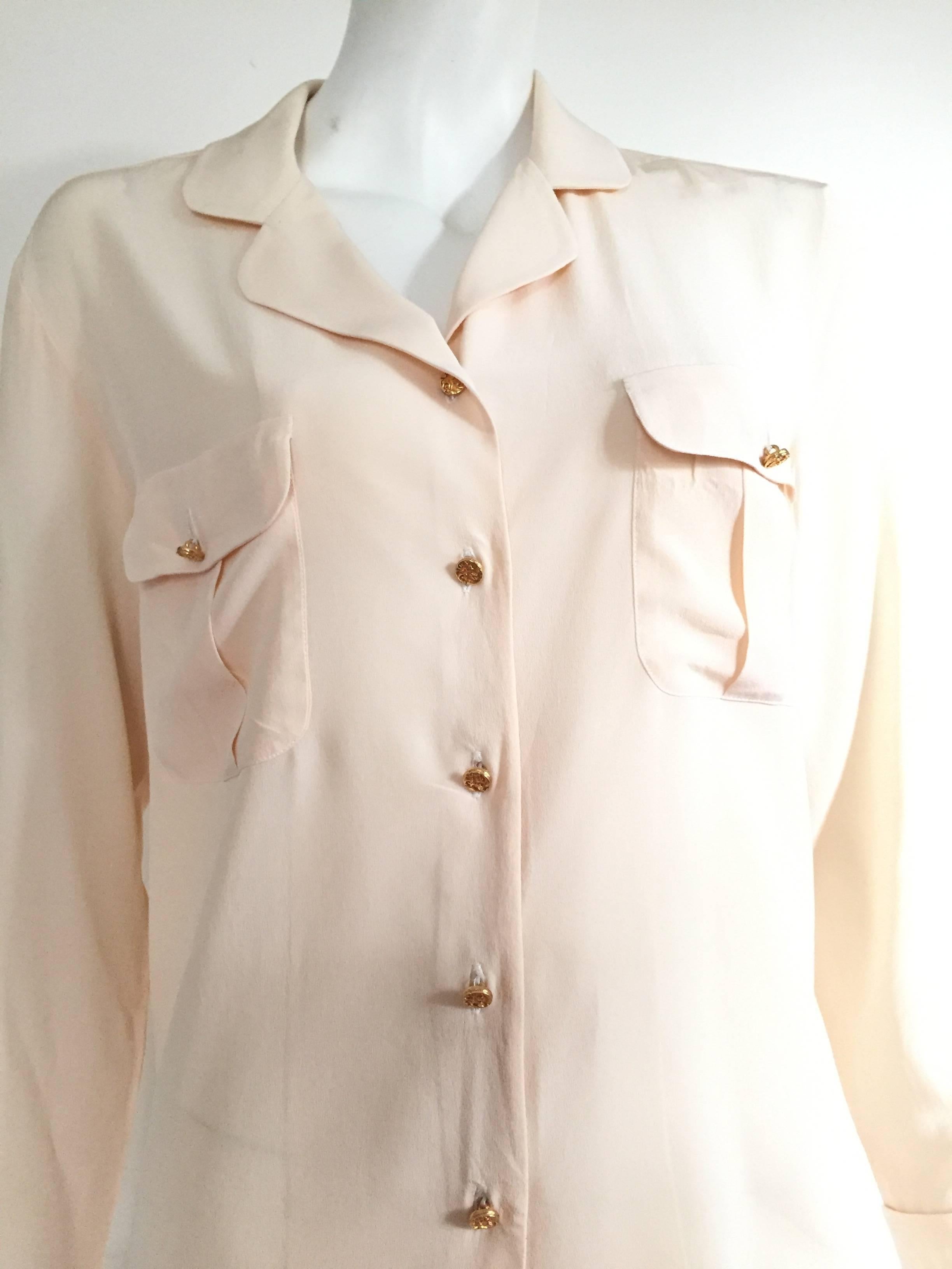 Chanel 1980s cream silk long sleeve blouse with gold buttons and front pockets and French cuff sleeves is a size 6 ( Please see & use the measurements below to properly measure your lovely body to make sure this blouse will fit you the way Coco