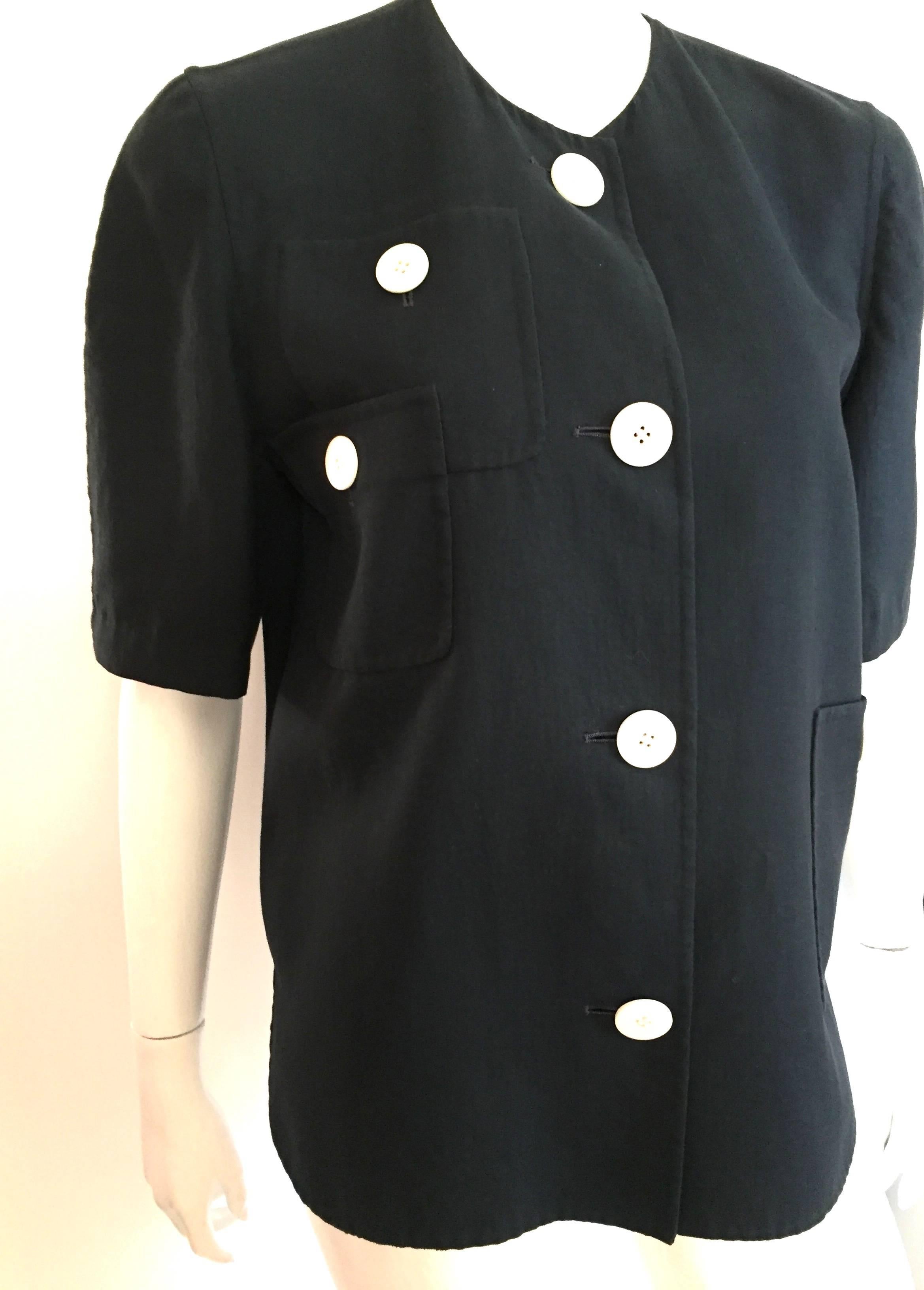 Bill Blass 1980s navy cotton whimsical design short sleeve top with big white round buttons is a vintage size 10.  Ladies please use your tape measure so you can properly measure your bust to make certain this is how Bill Blass wanted it to look on