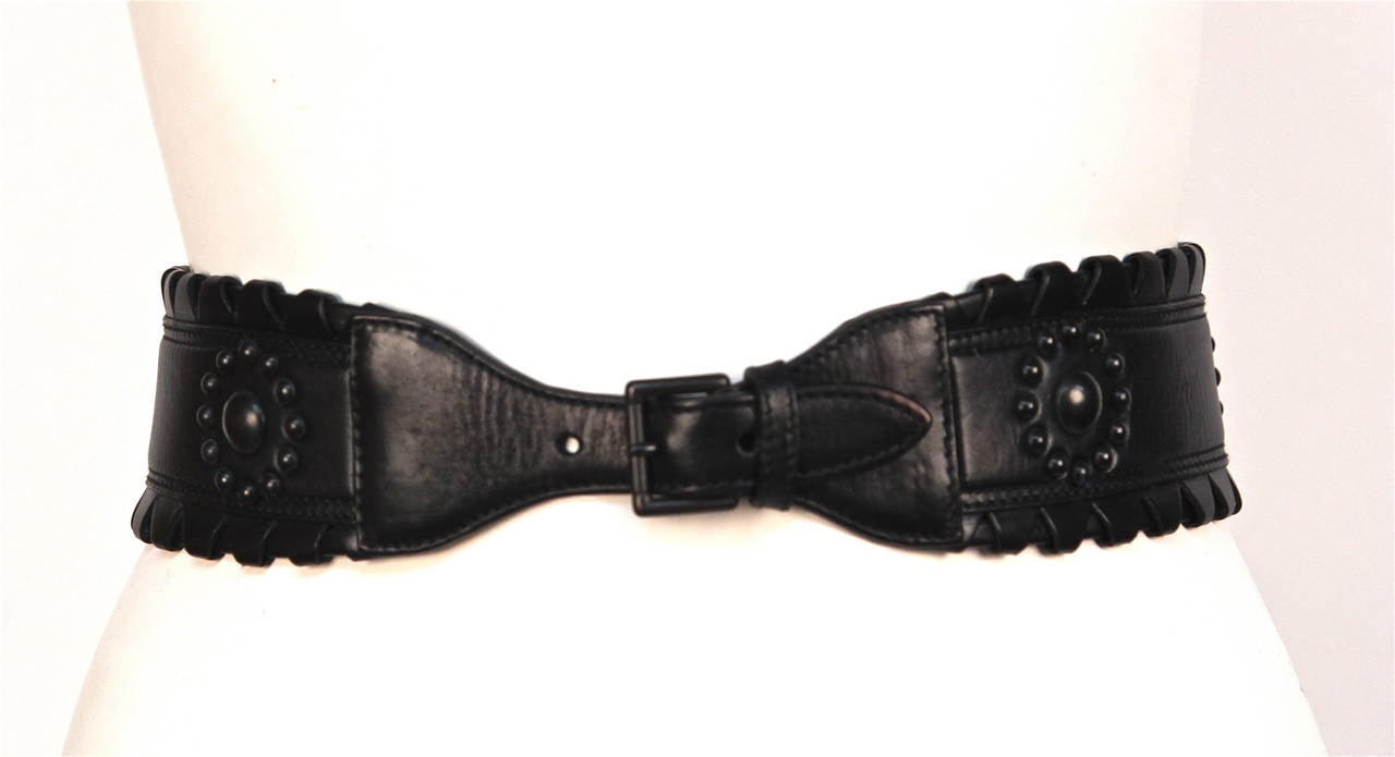 Jet black leather belt with black studs from Azzedine Alaia. Belt is labeled French size 65 and fits a size XS. Belt measures 28
