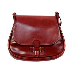 1974 HERMES burgundy box leather saddle bag with gold hardware