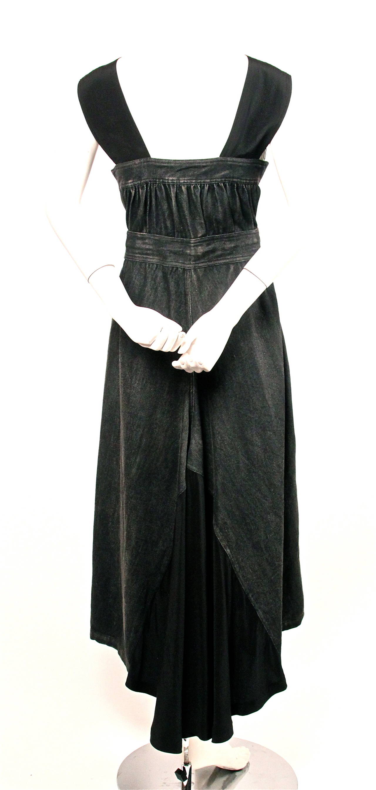 Very dramatic dress from Yohji Yamamoto dating to the early 2000's. Made of black cotton denim with silk /cashmere inserts. Dress can be worn a number of ways. Zips up center front with adjustable button closure at waist. Patch pockets at hips.