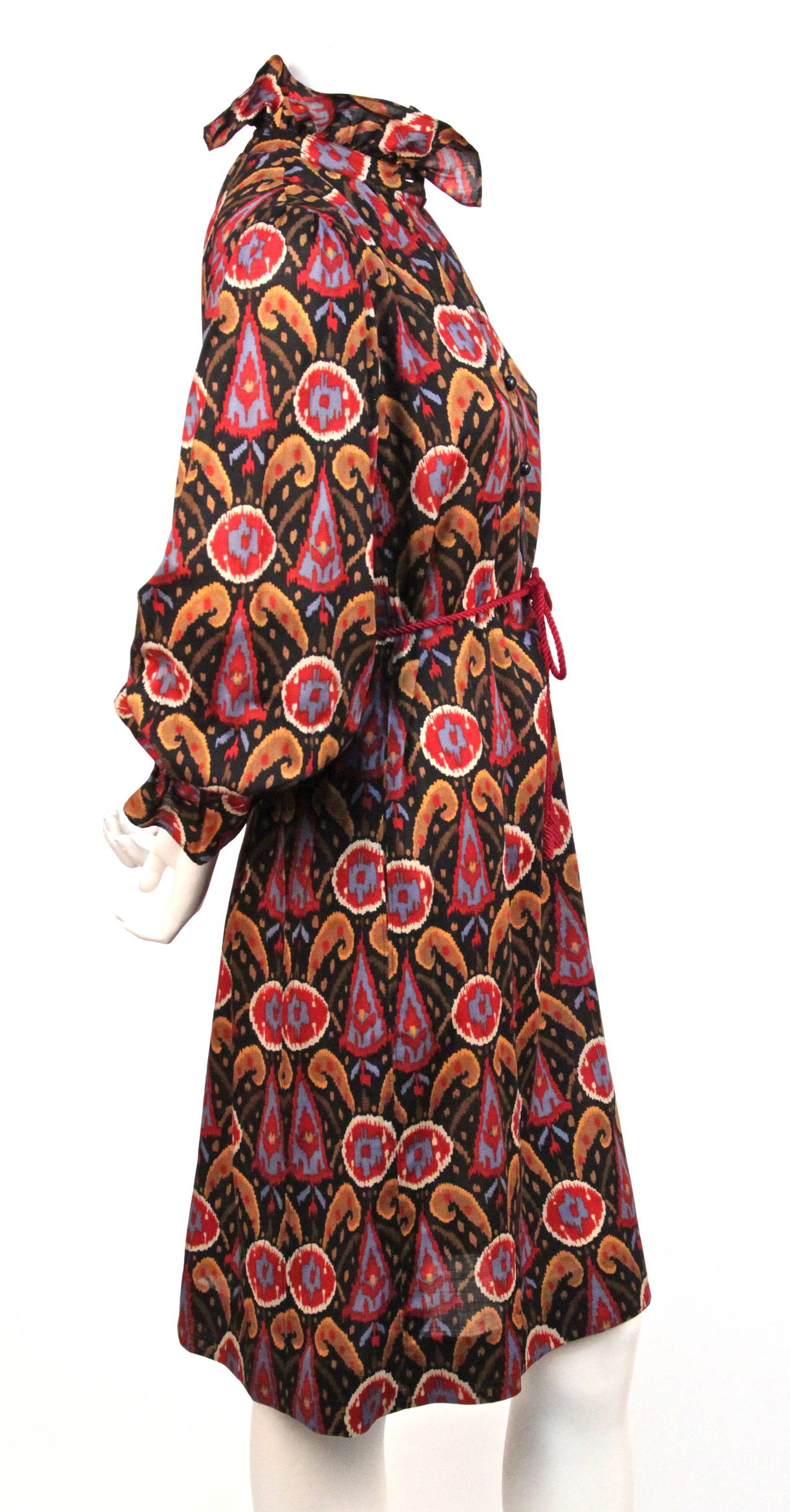 Vivid ikat printed wool challis dress from Yves Saint Laurent dating to the 1970's. Labeled a French size 34 however this will also fit a French 36 or possibly even a petite French 38. Slips on over the head with button front placket and buttons as