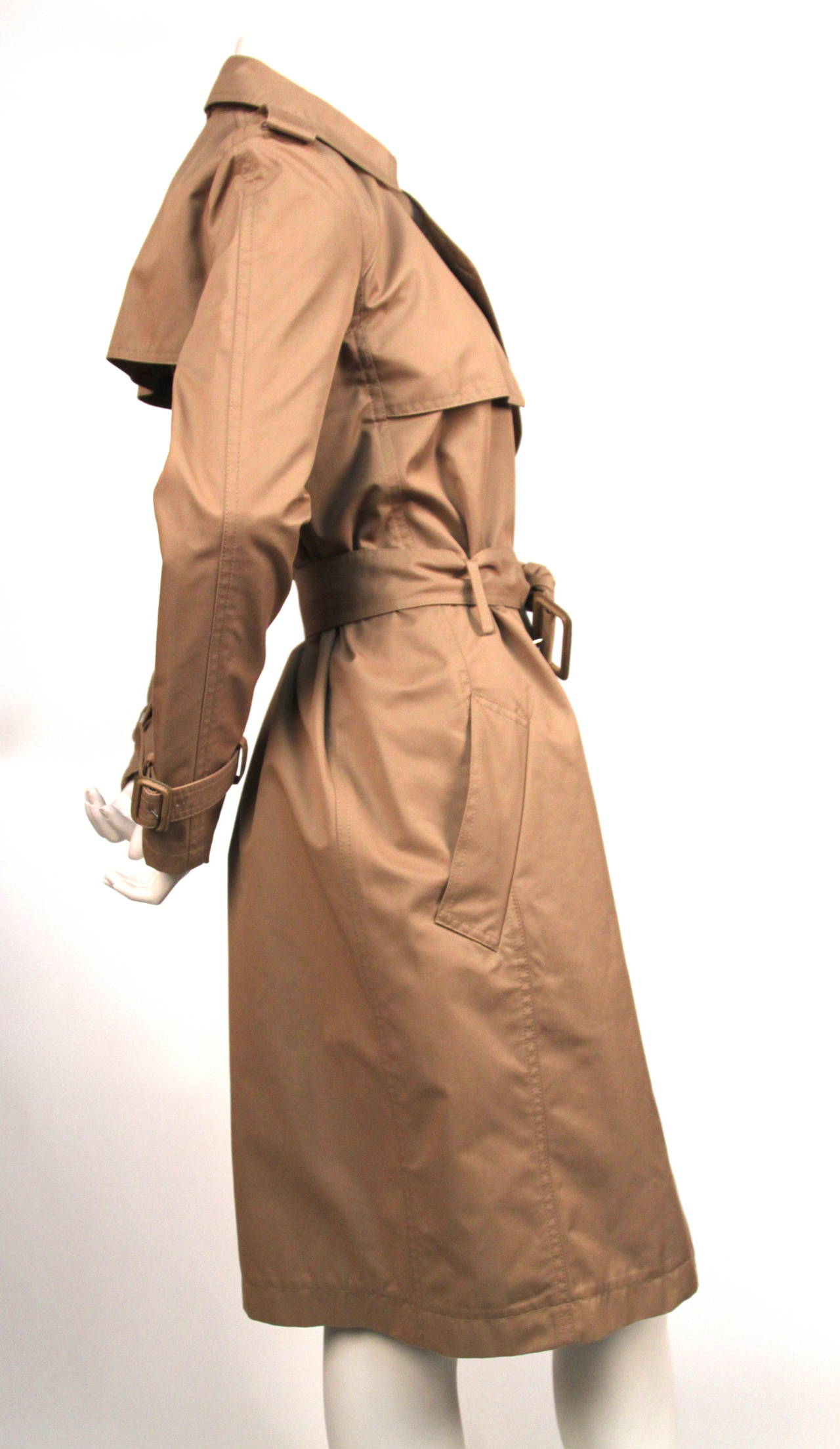 Classic tan trench by Phoebe Philo for Celine dating to fall 2012/13. Labeled a 
French size 36: approximate measurements: bust and waist are adjustable, shoulder 16