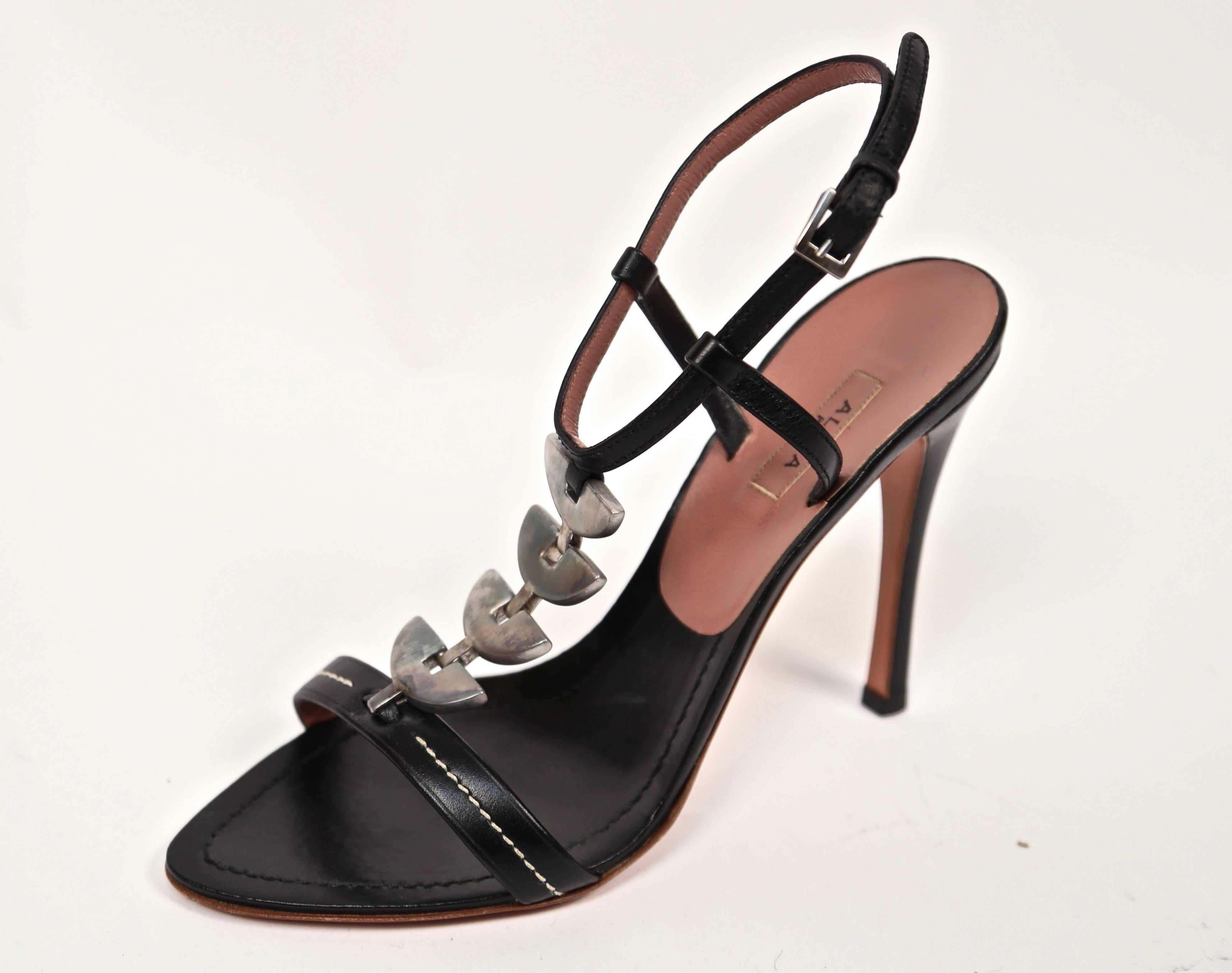 Jet black leather heels with silver hardware designed by Azzedine Alaia. French size 37. Approximate measurements: length just over 9.75