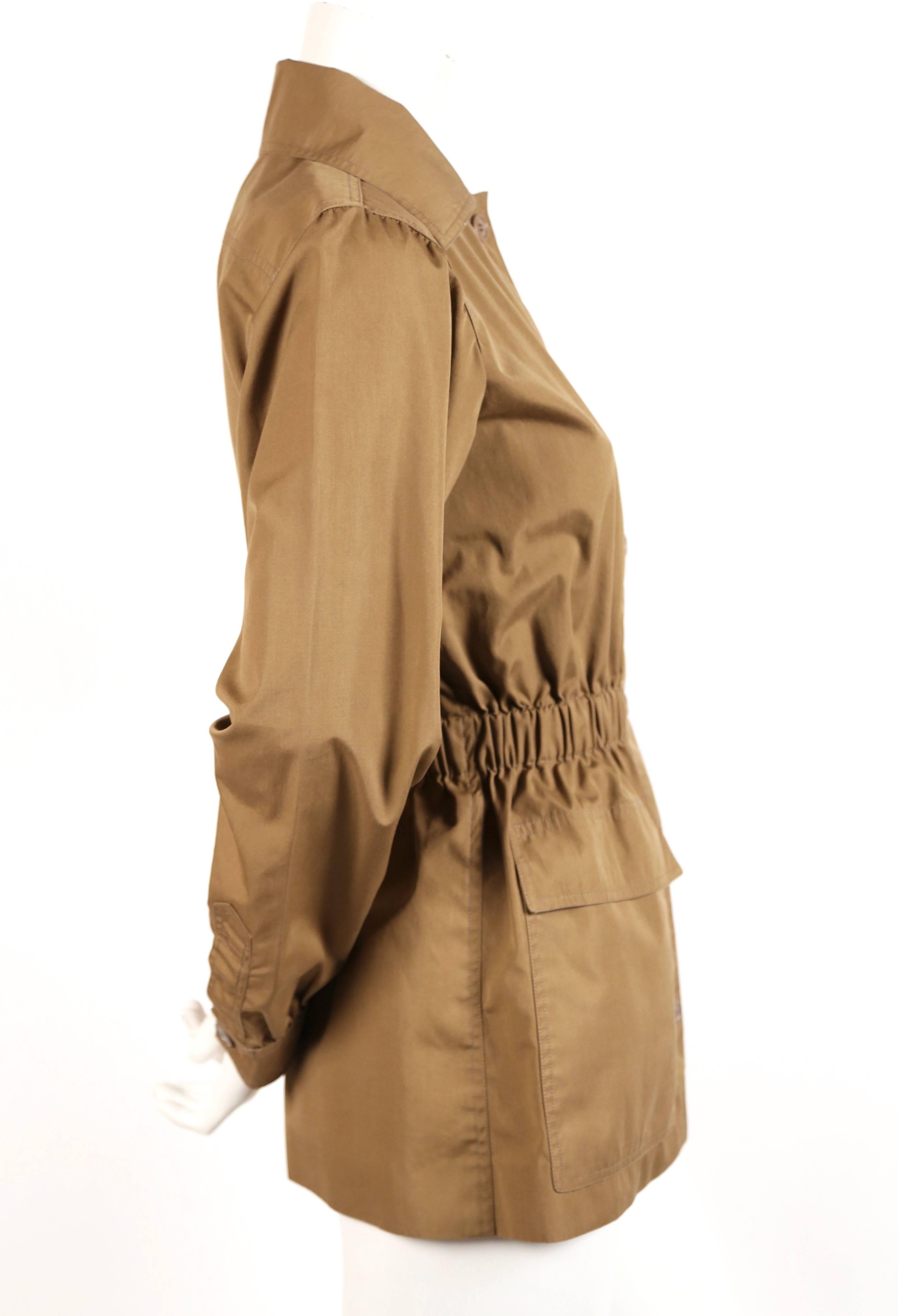 Khaki safari style jacket designed by Yves Saint Laurent dating to the early 1970's. Jacket best fits a US 2 to 4. Approximate measurements: 15