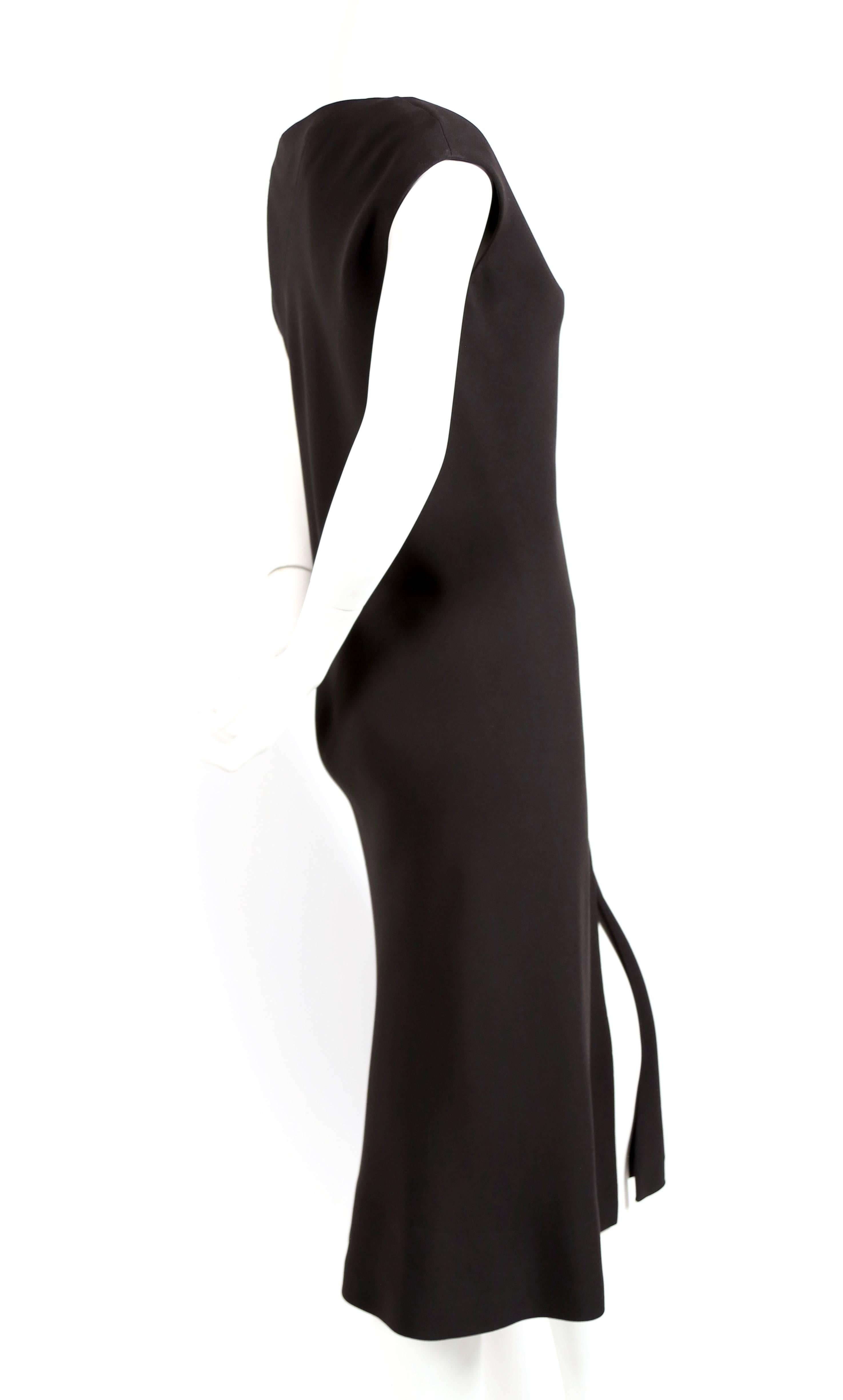 Jet black bias cut dress with high center front slit from Halston dating to the late 1970's. Fits a US 4-6. Approximate measurements are  34