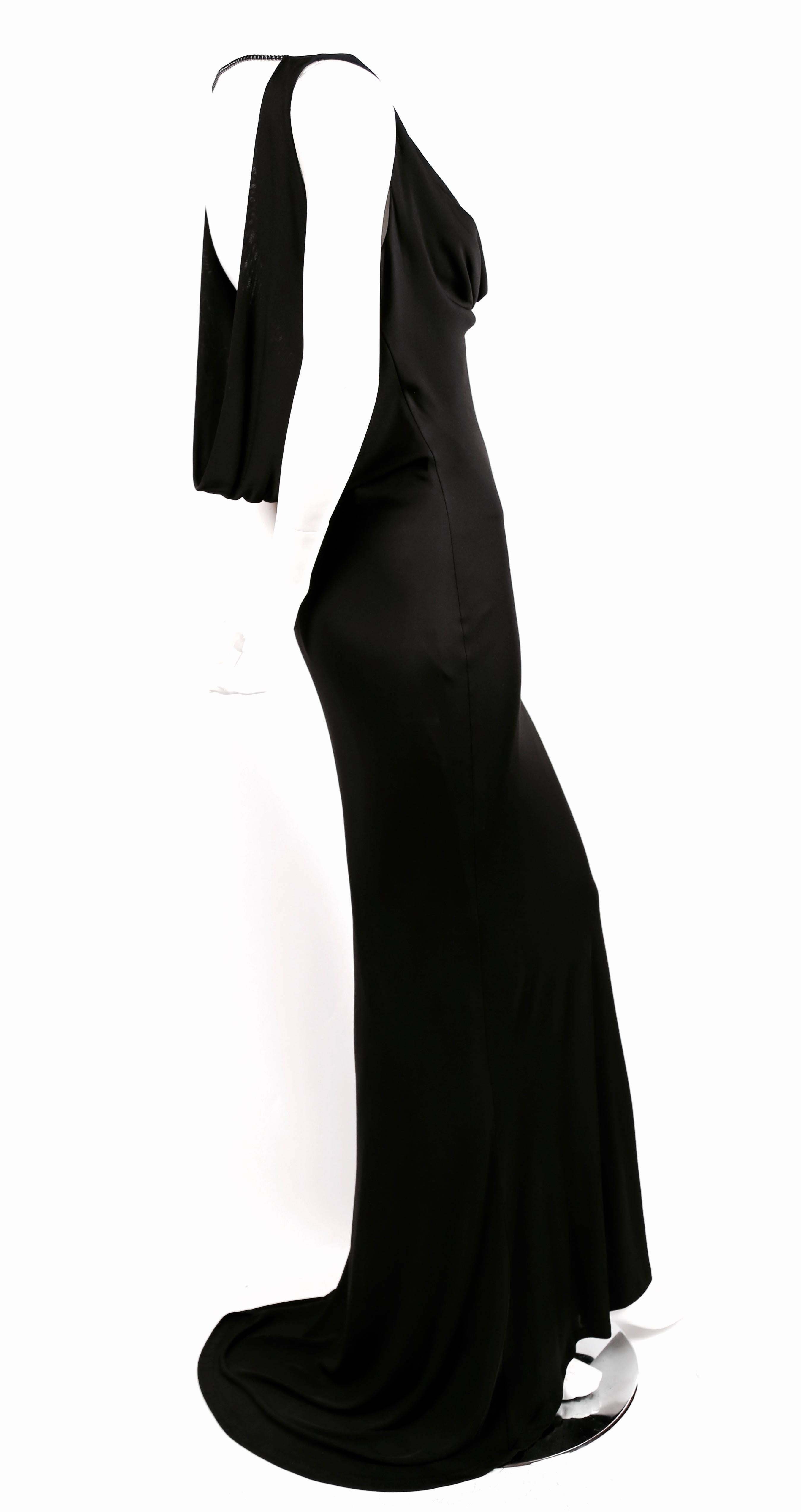 Jet black bias cut jersey gown with cowl neck and low back with gunmetal black chain detail at shoulders from Alexander McQueen dating to the mid 2000's. Dress is labeled an Italian size 42, however it best fits a US size 4 or 6. Bust stretches to a