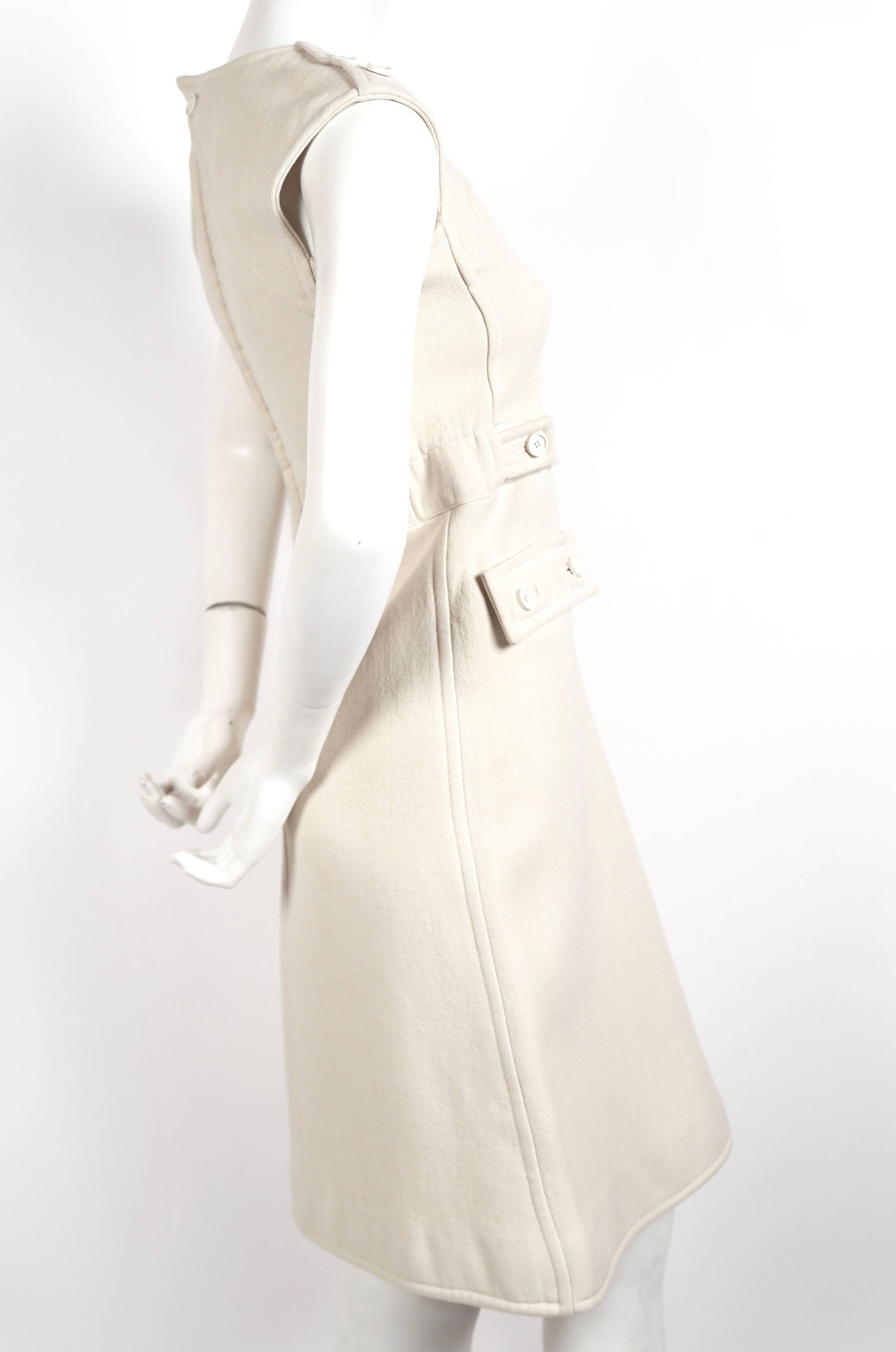 Off-white haute couture dress from Courreges dating to the 1960's. Dress best fits a size 0 or 2. Approximate measurements are as follows: bust 31