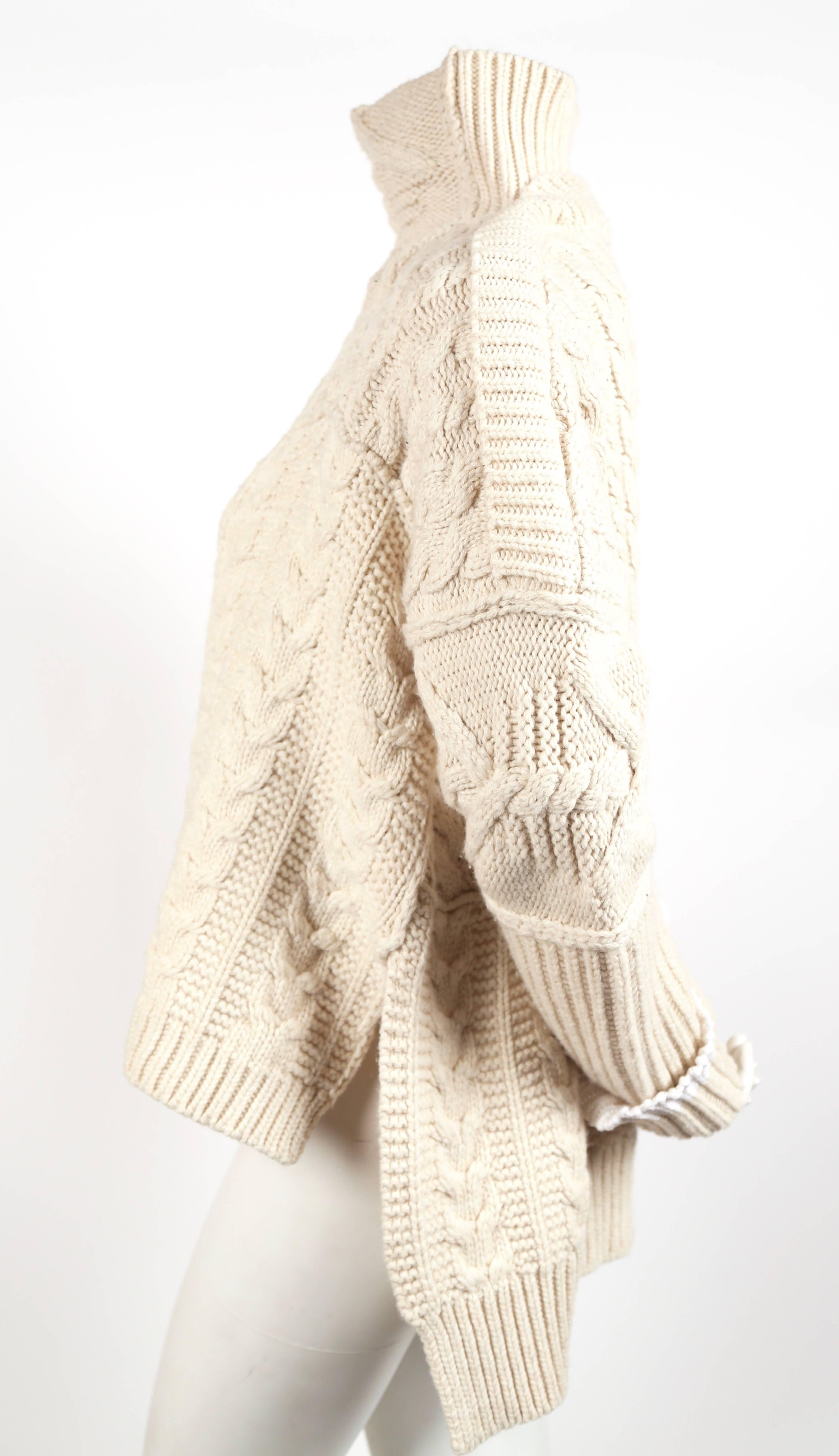 Cream cable knit wool sweater designed by Phoebe Philo for Celine dating to fall of 2010. French size 'S'. Approximate measurements: shoulder seam to shoulder seam (dropped shoulder cut) 30", bust 54", arm length from underarm to cuff