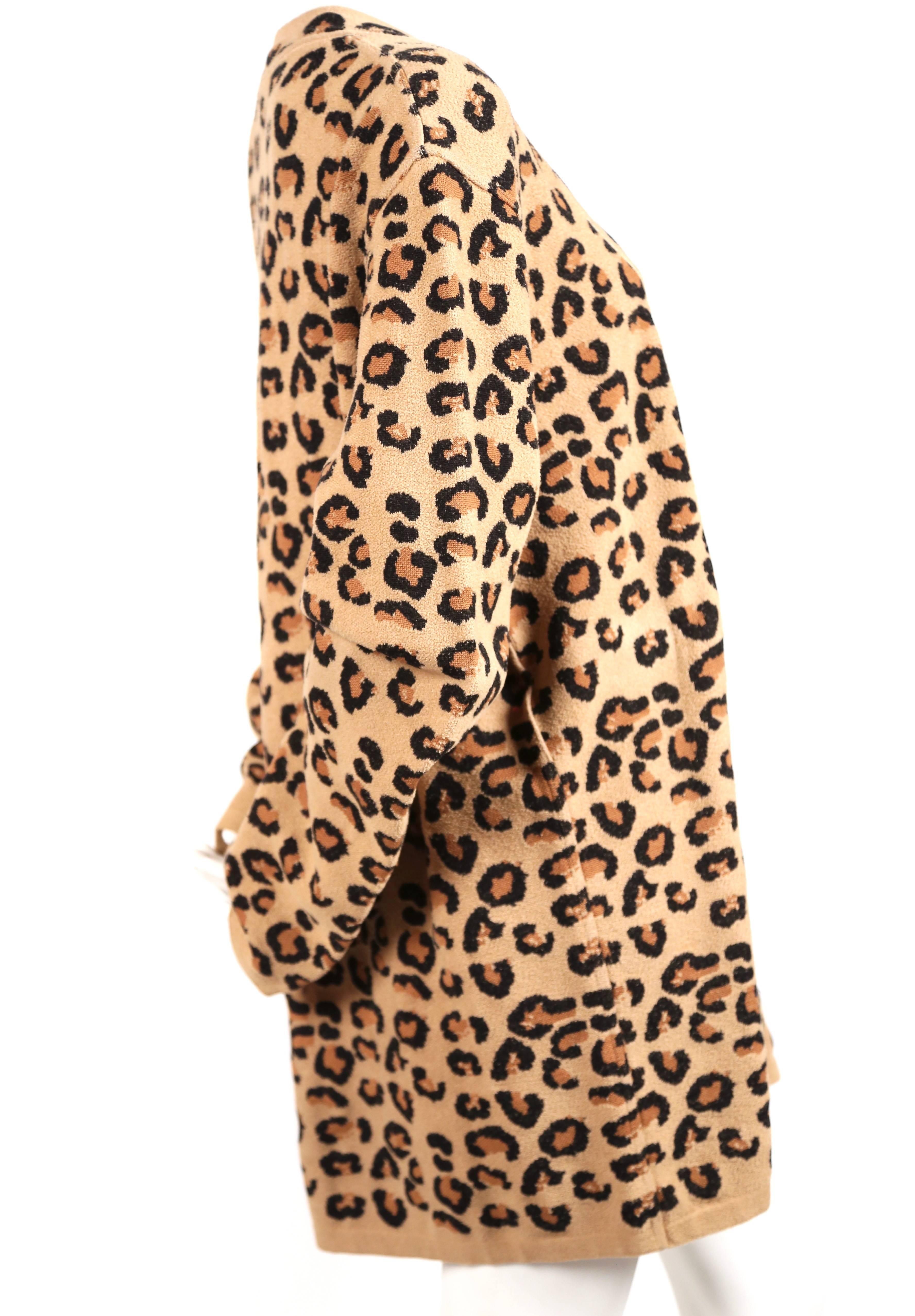 Extremely rare oversized V-neck woven leopard knit tunic dress from Azzedine Alaia dating to fall of 1991. Labeled a size S. Approximate un-stretched measurements: shoulders 21", bust 50", hem width 46", arm length (un-cuffed)