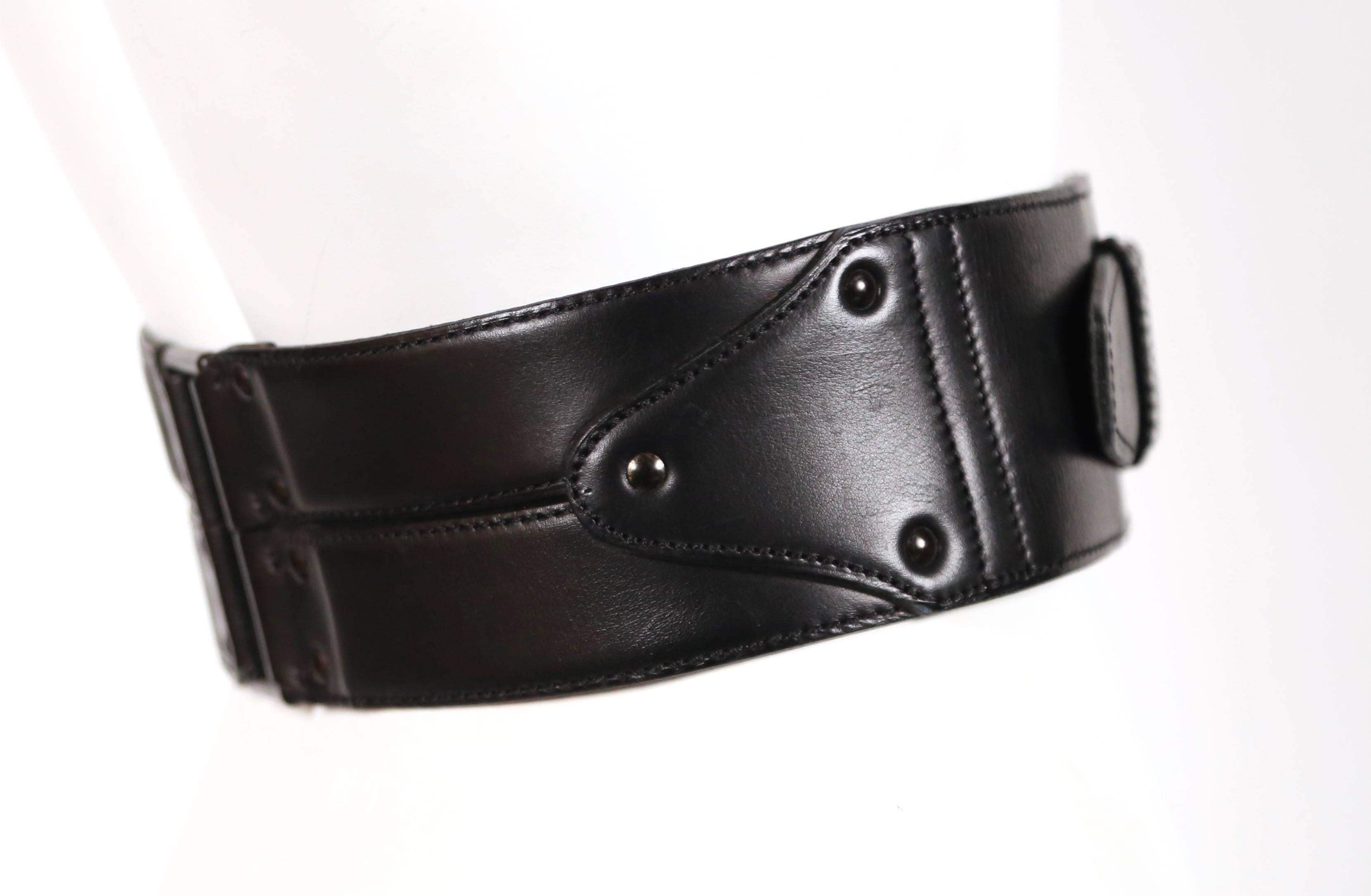 Jet black asymmetrical leather belt designed by Azzedine Alaia dating to the late 1980's, early 1990's. French size 65. Belt holes fall at 23.25