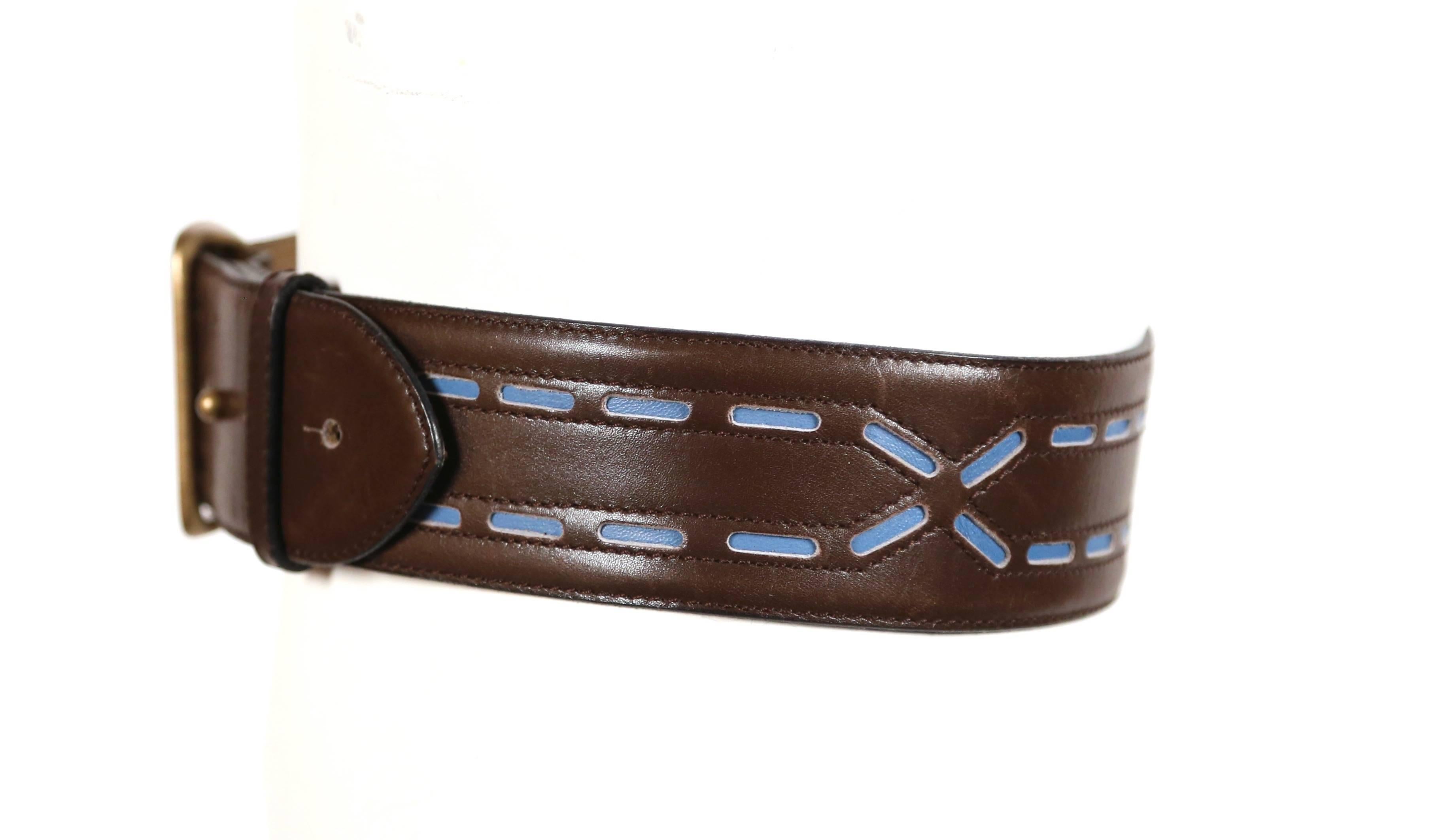 Dark brown leather belt with brass buckle and blue leather accents designed by Azzedine Alaia dating to the 1990's. French size 70. Holes fall at approximately: 25